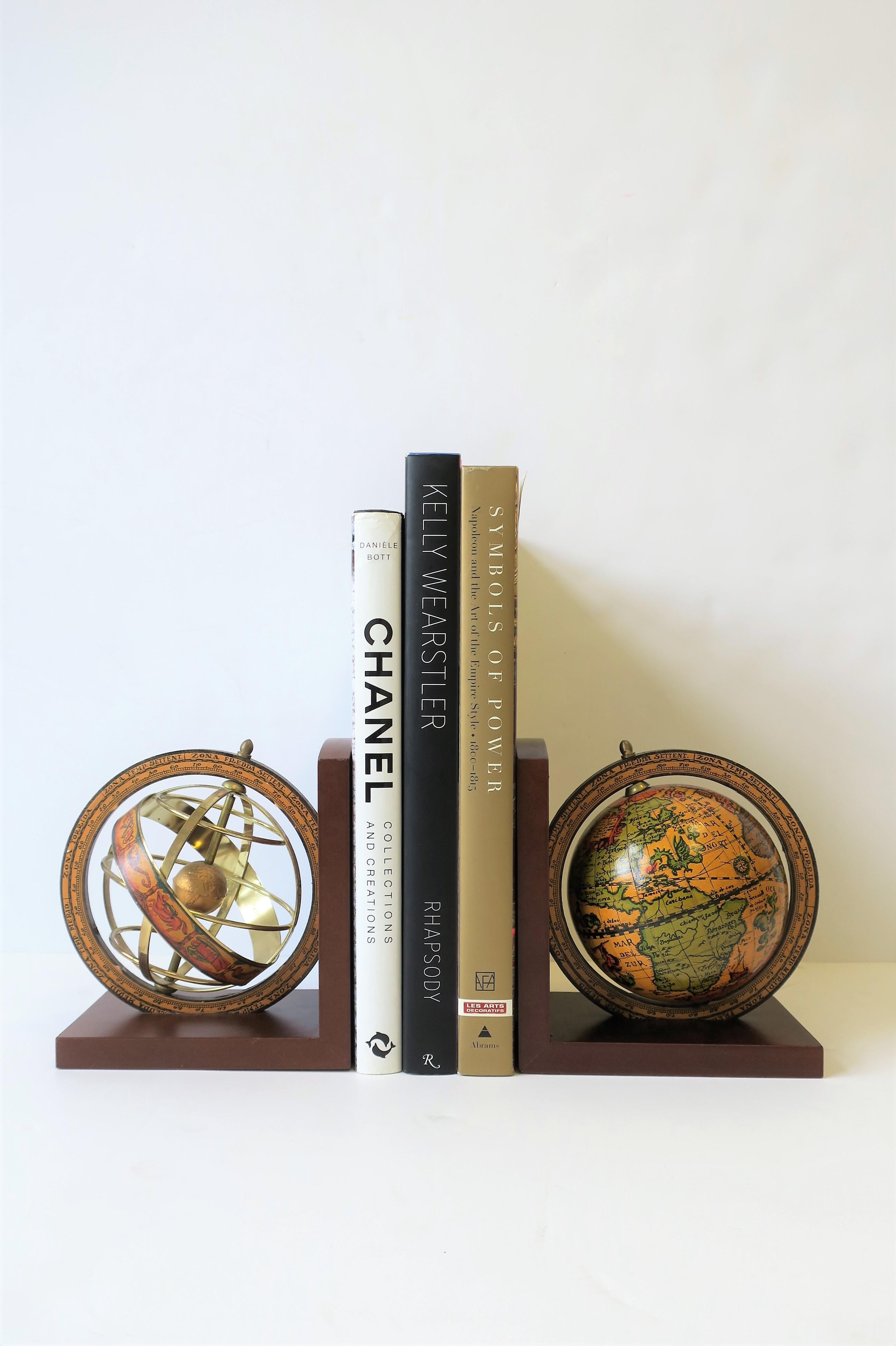 A pair of midcentury Italian world globe bookends, made in Italy. Bookends are brass, wood and paper with unique cut-out design with mini globe inside. Marked on bottom as show in image #6.