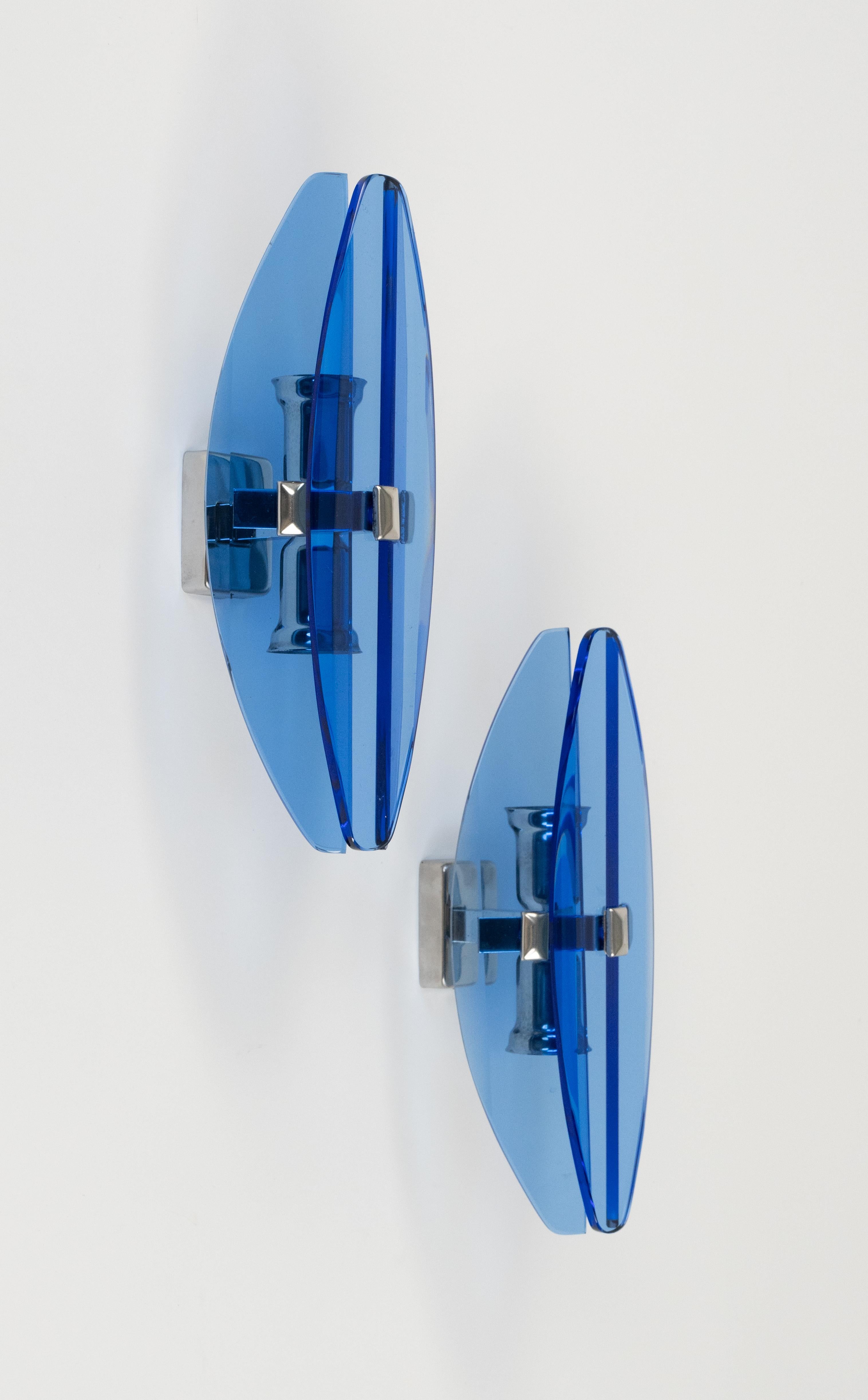 Midcentury beautiful pair of wall sconces in colored glass blue and chrome by Veca.  

Made in Italy in the 1970s.  

They are wired for the United States or Europe and operate on 110 or 220 Volts.  