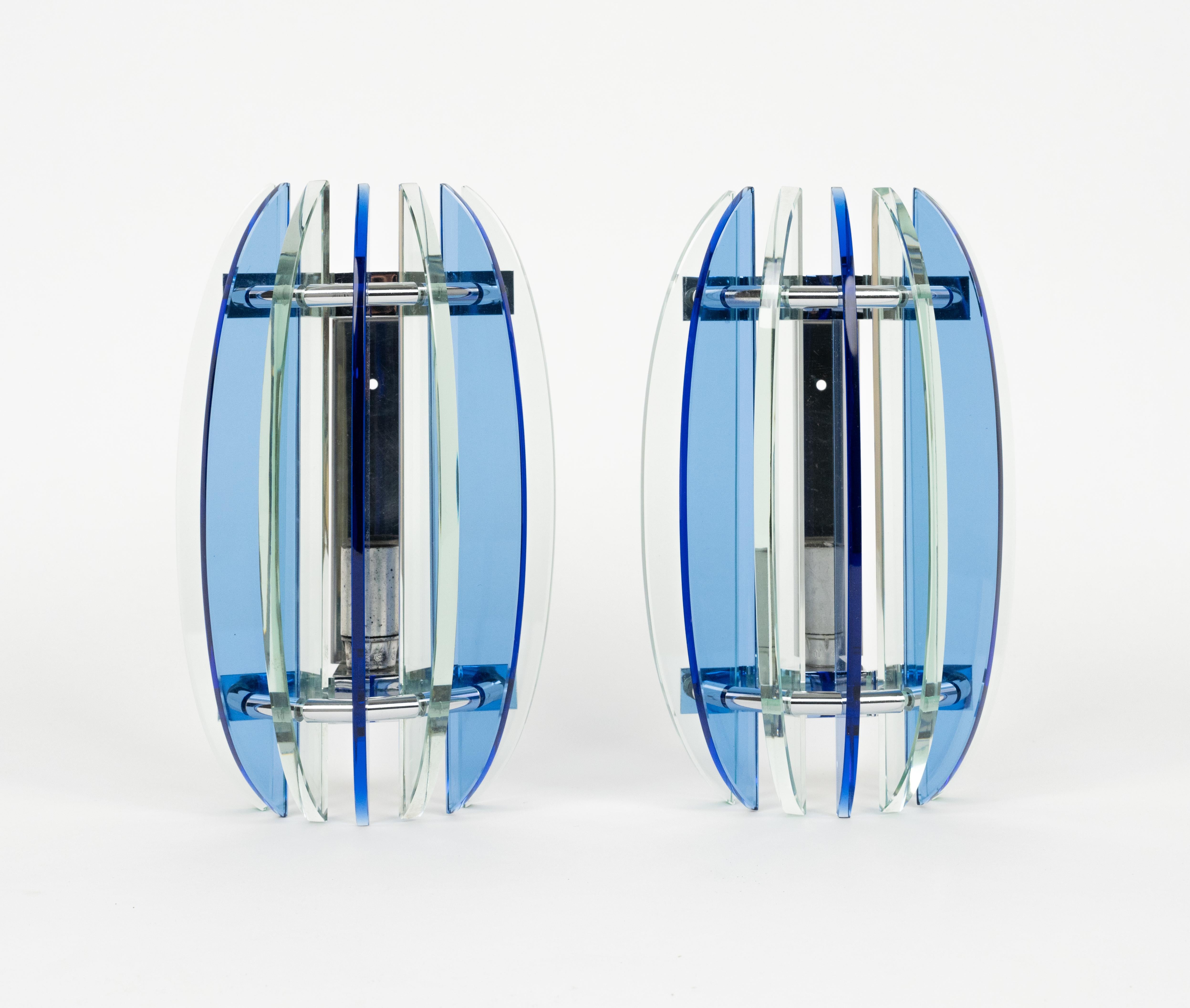 Midcentury beautiful pair of wall sconces in colored glass (blue and green) and chrome by Veca.  

Made in Italy in the 1970s.

The original label is still attached as shown in the pictures.