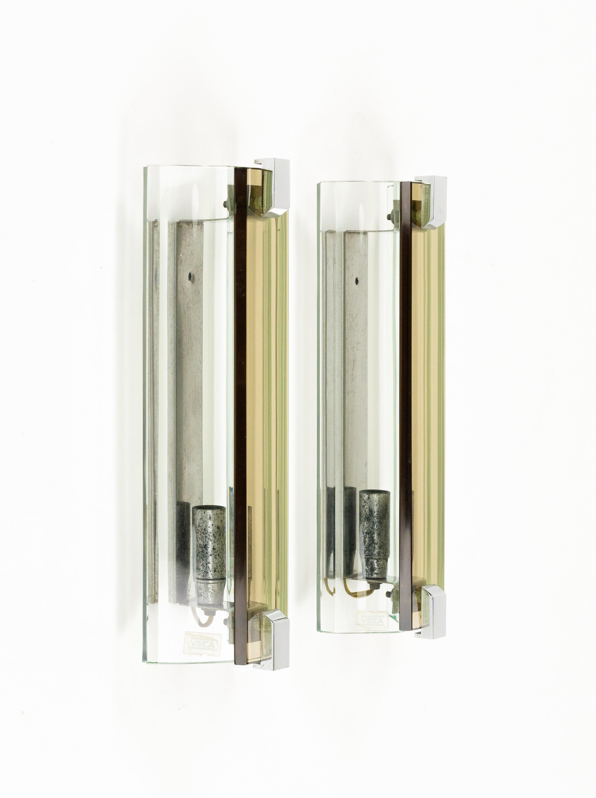 Midcentury beautiful pair or sconces in glass (green and bronze) and steel  by Veca.

Made in Italy in the 1970s.

The original label is still attached as shown in the pictures.
