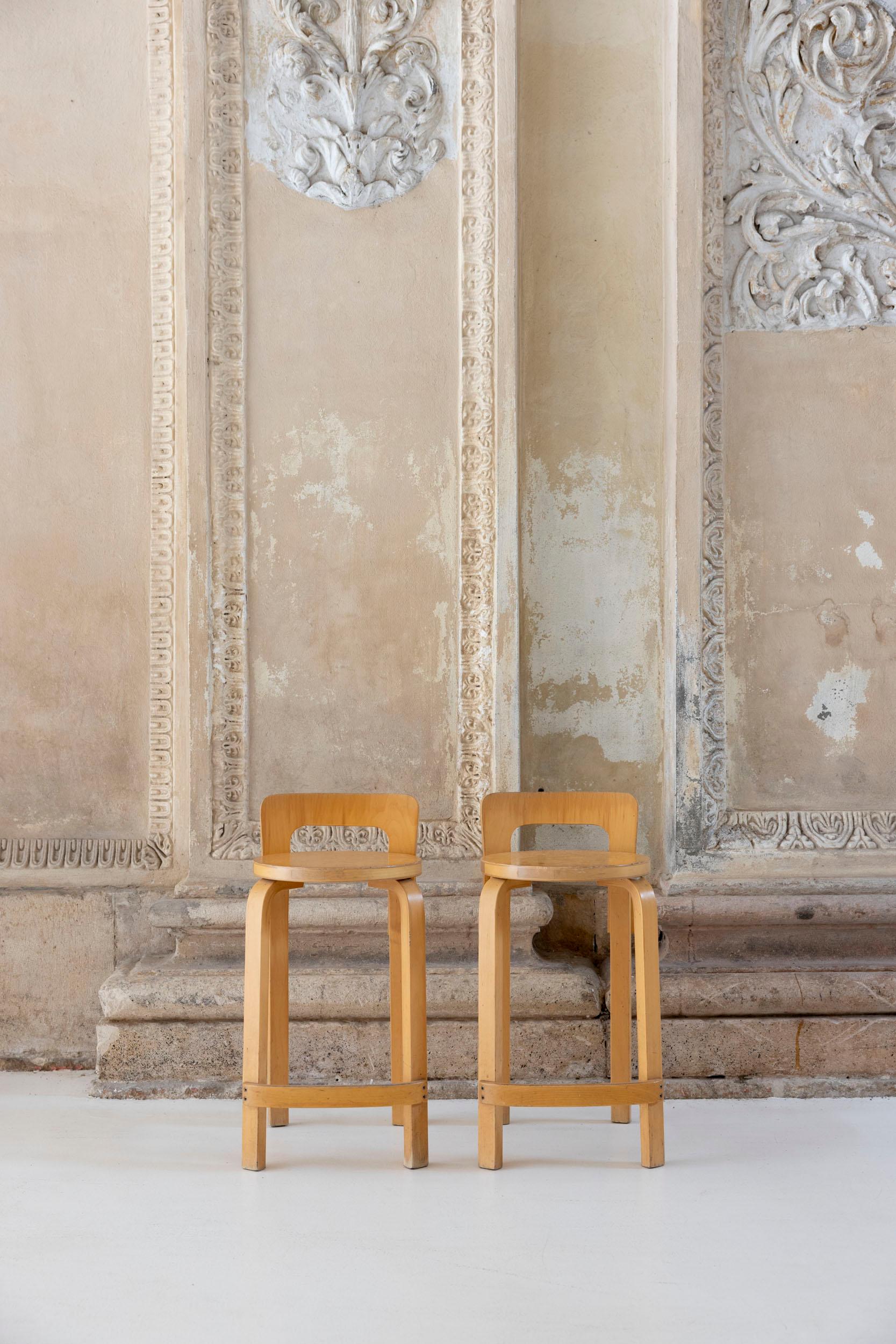 The K65 model stool was designed by Alvar Aalto between 1933 and 1935. The height is designed for combinations with high tables or counters. The low backrest provides the right support for the back, and the curved crosspiece at the bottom provides