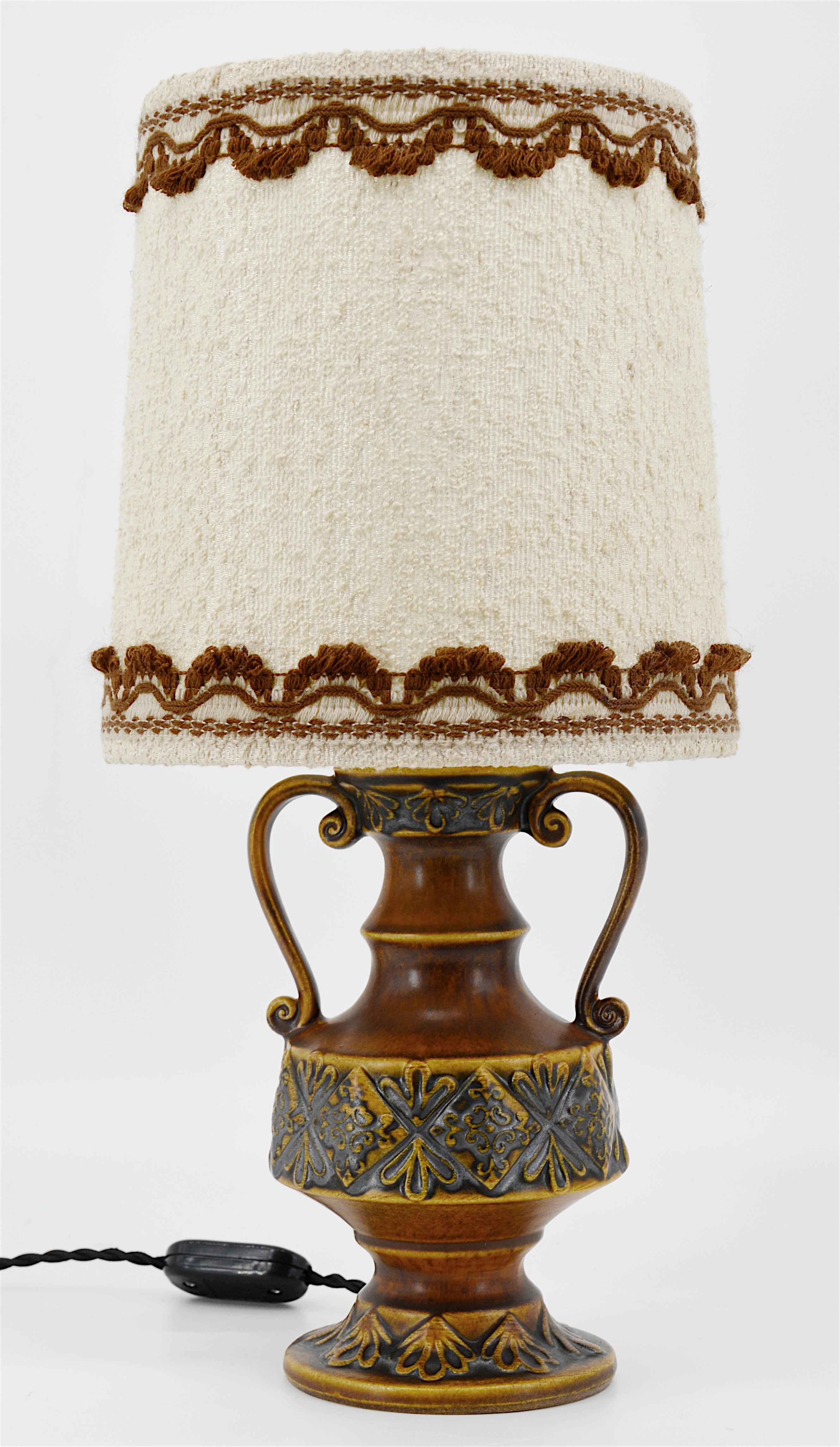 Midcentury pair of table lamps, Germany, early 1970s. These ceramic bases come with their original tissue shade. Measures: Full height 41cm, 16.1 inches. Height of the ceramic base 20cm, 7.9 inches. Diameter 21cm, 8.3 inches. Some slight traces of