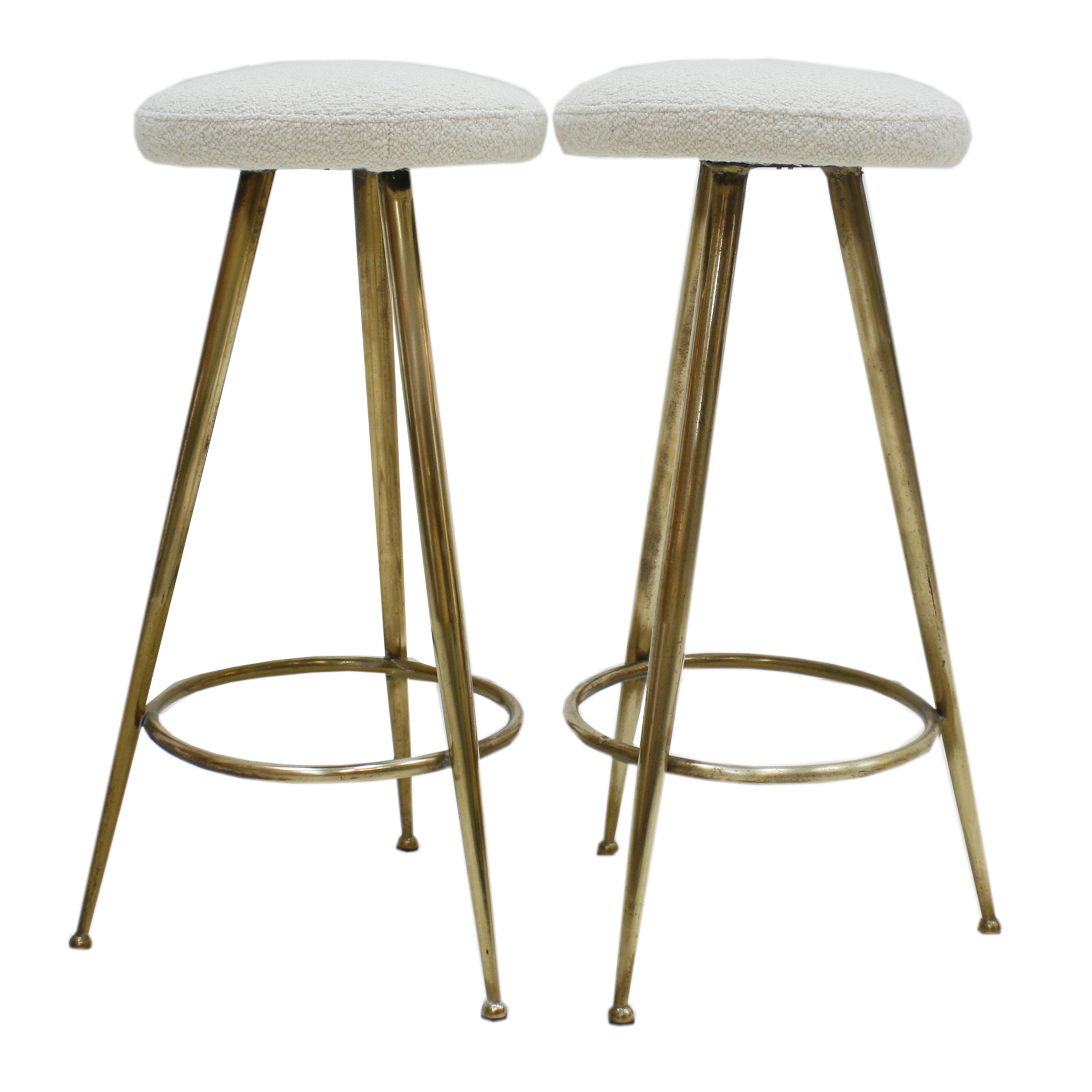 Midcentury pair of circular Italian stools attributed to Gio Ponti (Milano 1891-1979 ). Made of brass structure with three legs and circular seat composed of solid wood frame, reupholstered in wool blouclé fabric. Italy 1950s.

Giovanni “Gio”