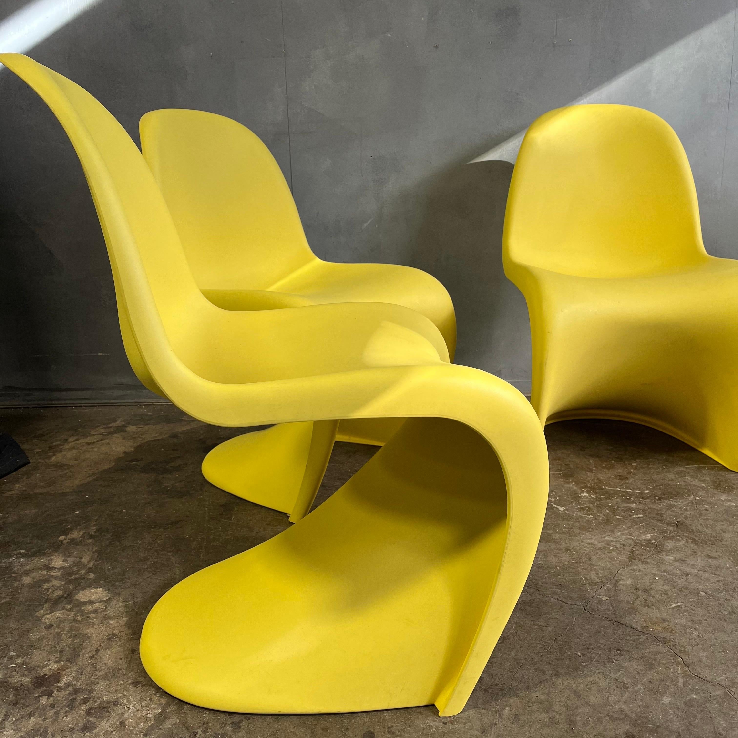 Iconic chairs designed by Verner Panton for Vitra in rare yellow. In wonderful condition showing very little wear. The Panton chair is constructed from a single mold of plastic in a matte finish. Vitra treated these chairs with a special additive to