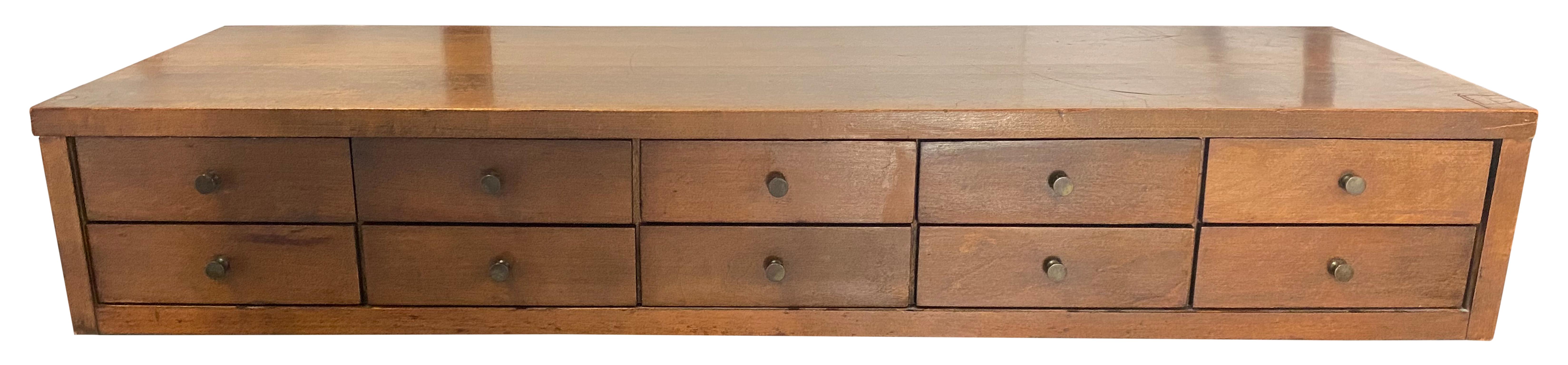 Rare Paul McCobb #1502 3' small chest of drawers in solid maple construction with walnut finish. Very high quality construction with original brass pulls black coated. Made for top of dresser or bookcase. 10 brass knobs 10 individual drawers.
