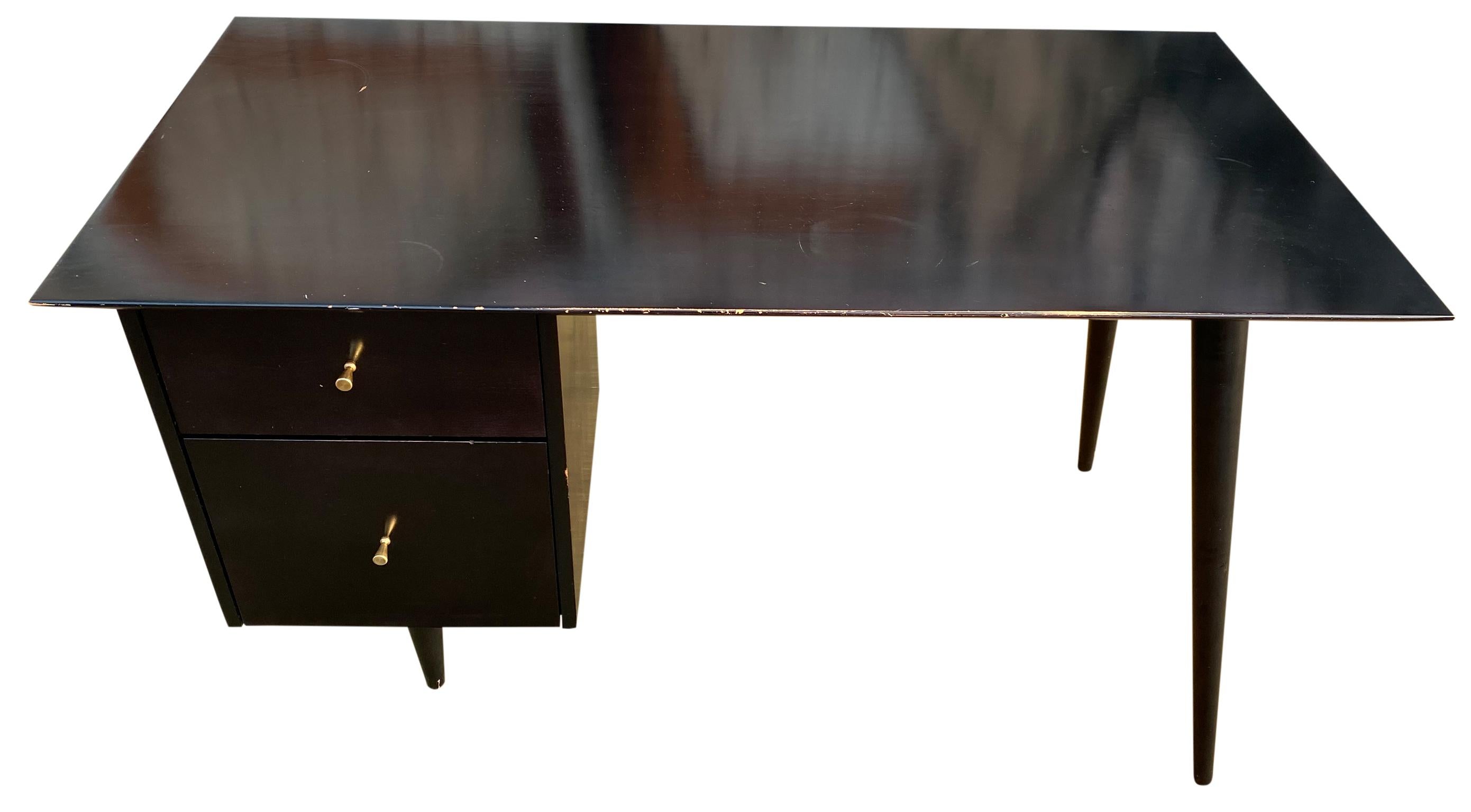 Beautiful Paul McCobb Planner Group #1560 double drawer desk Black Lacquer on maple with brass knobs solid maple. Desk is in great original vintage condition. Very beautiful designed desk on tapered legs - all solid maple. All legs unscrew. Drawers