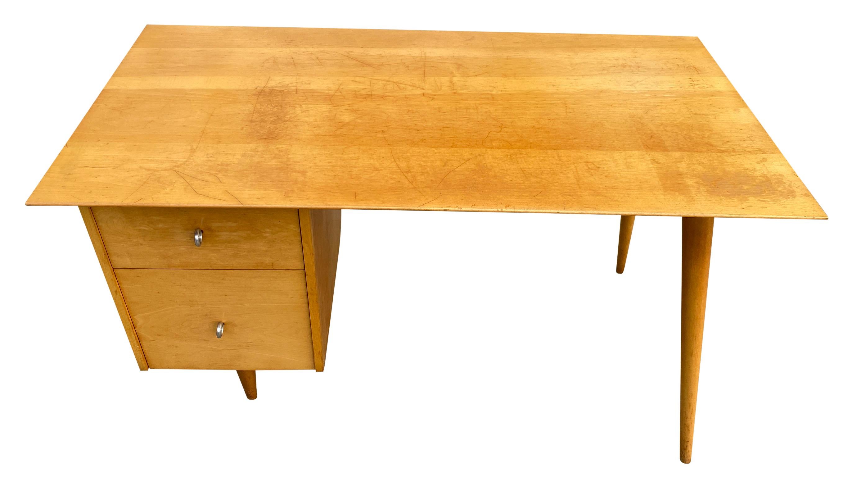 Beautiful Paul McCobb Planner Group #1560 double drawer desk blonde maple finish with Aluminum ring pull knobs solid maple. Desk is in good original vintage condition top shows little wear. Very beautiful designed desk on tapered legs, all solid