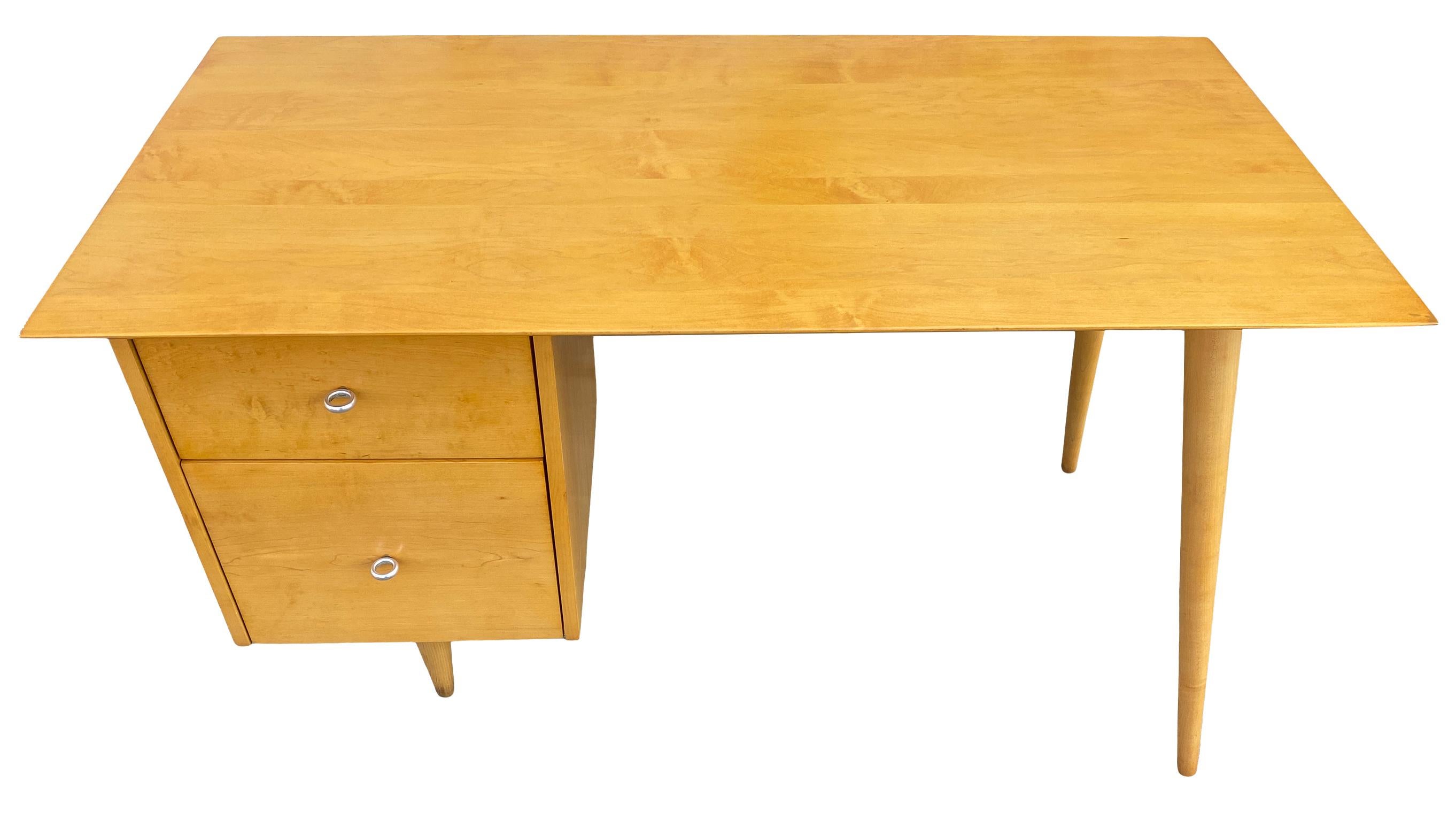 Beautiful Paul McCobb Planner Group #1560 double drawer desk blonde maple finish with aluminum ring pull knobs solid maple. Desk has been professional refinished. Very beautiful designed desk on tapered legs, all solid maple. All legs unscrew.