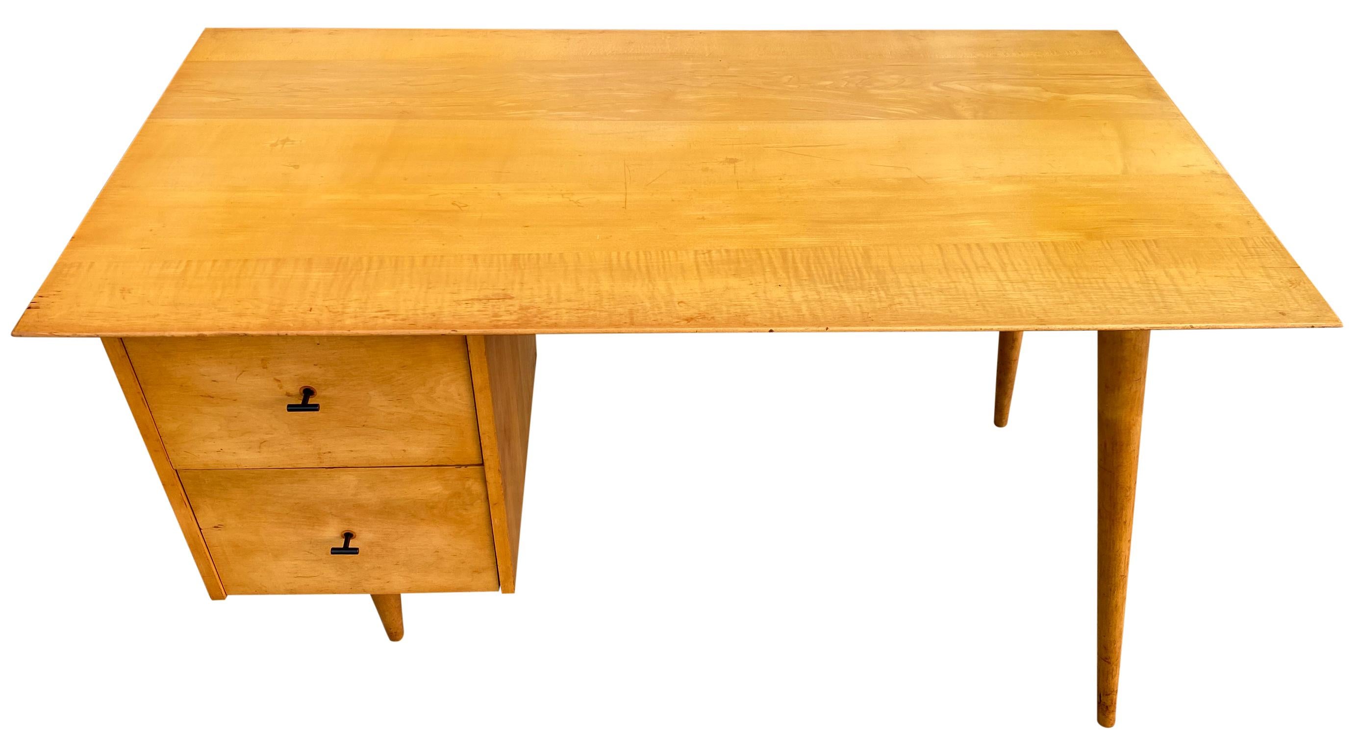 Beautiful Paul McCobb Planner Group #1560 double drawer desk blonde maple finish with steel T pull knobs solid maple. Desk is in great original vintage condition. Very beautiful designed desk on tapered legs, all solid maple. All legs unscrew.