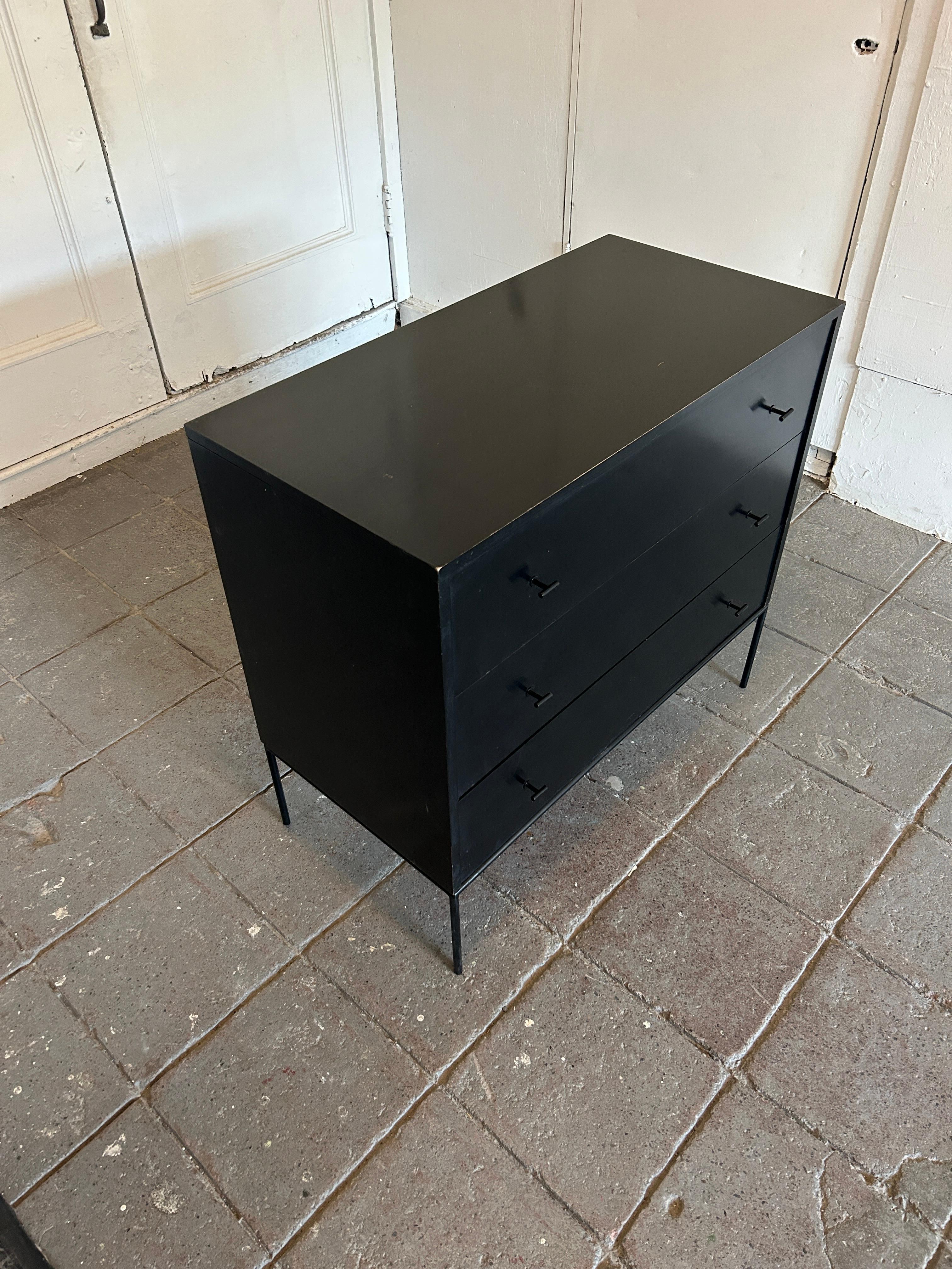 Mid-Century Modern black lacquer three-drawer dresser by Paul McCobb for Winchendon Furniture Company. All Original Black Lacquer paint finish with Blonde maple drawer insides. Black Steel T Pulls and Iron base. Labeled inside drawer with foil