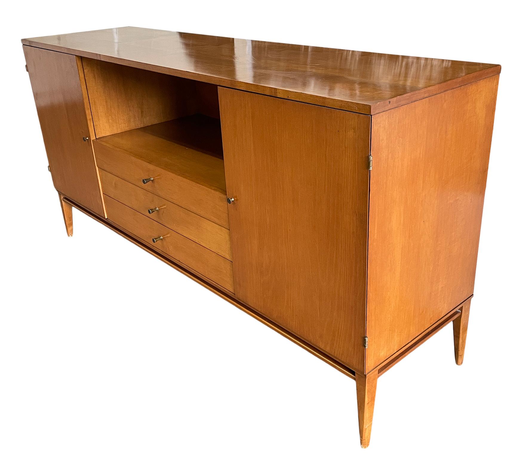 Vintage midcentury Paul McCobb three-drawer dresser credenza with (2) cabinets on each end that has (1) adjustable shelf in each side. Beautiful Credenza by Paul McCobb circa 1950s Planner Group, 3 center drawers, solid maple, Brass cone pulls and