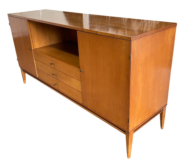 Vintage midcentury Paul McCobb three-drawer dresser credenza with (2) cabinets on each end that has (1) adjustable shelf in each side. Beautiful Credenza by Paul McCobb circa 1950s Planner Group, 3 center drawers, solid maple, Brass cone pulls and