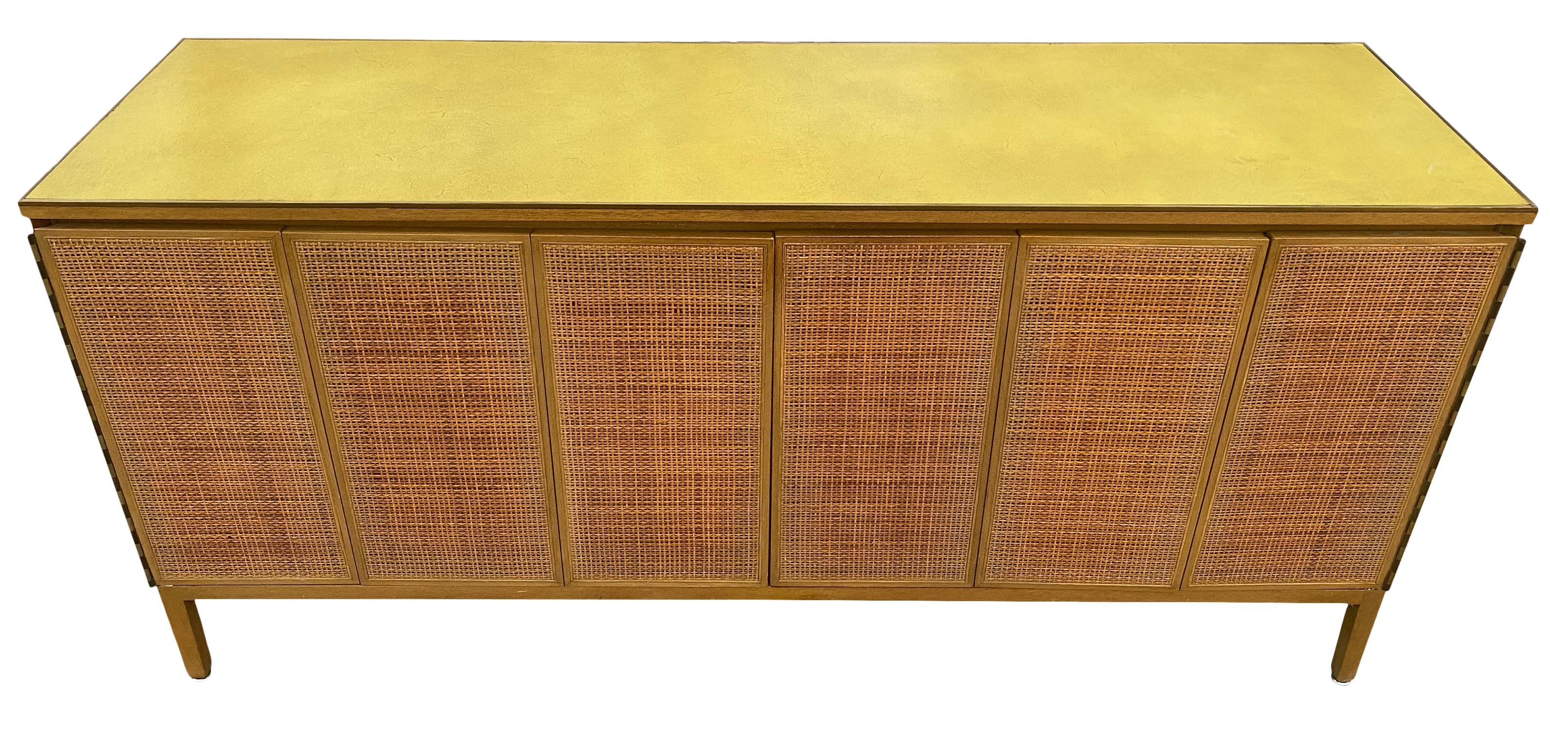 Midcentury American designer Paul McCobb 8-drawer dresser credenza #7707 medium Light tan mahogany finish. Original finish in beautiful vintage condition, has original Rare Yellow leather brass lined top with folding cane front doors in amazing