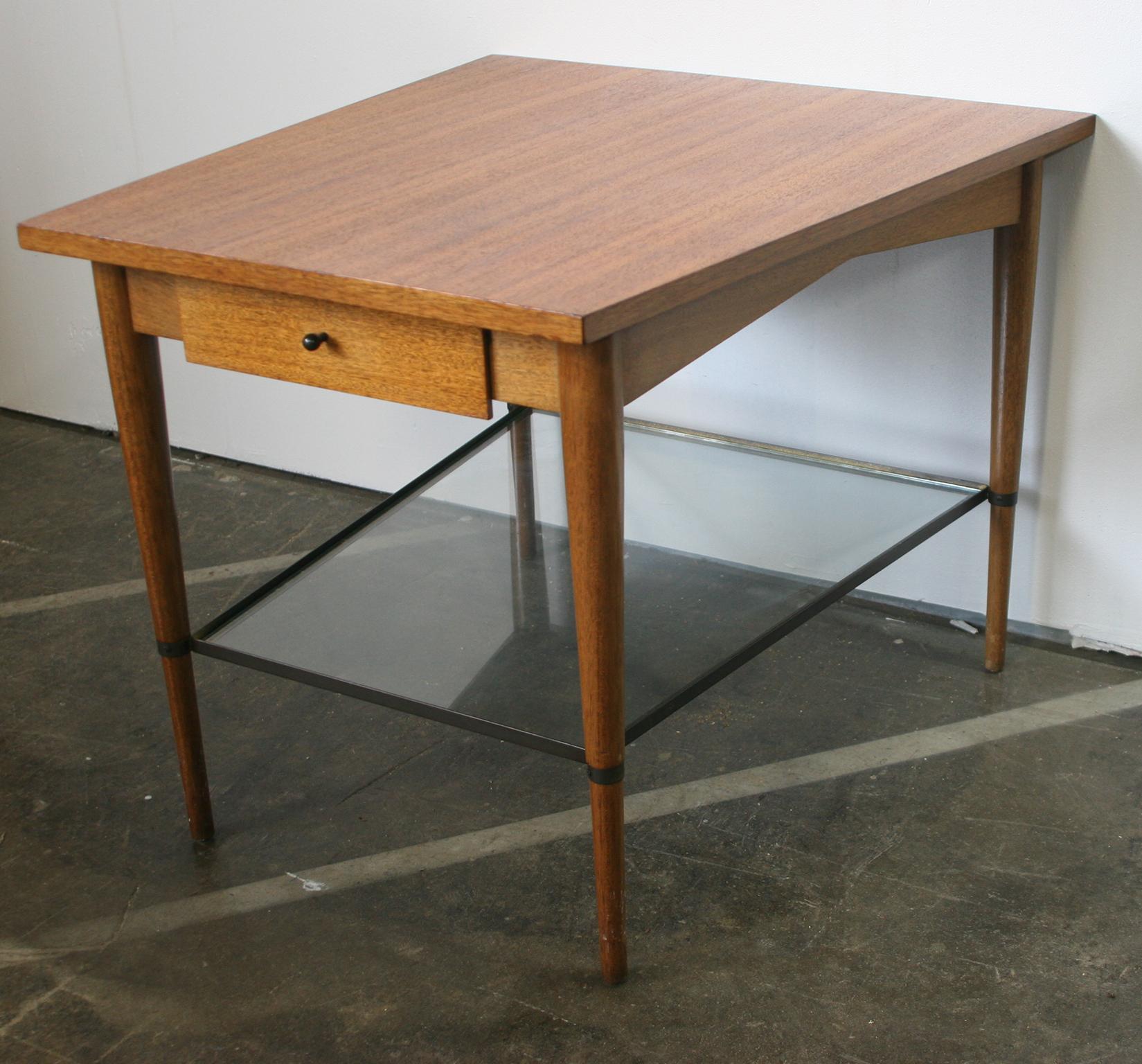Beautiful rare single midcentury Paul McCobb Connoisseur collection single drawer wedge table end table. Black tear drop knob. Original finish from 1960s. Very modern designed side table with brass and glass lower shelf 4 tapered legs. All solid