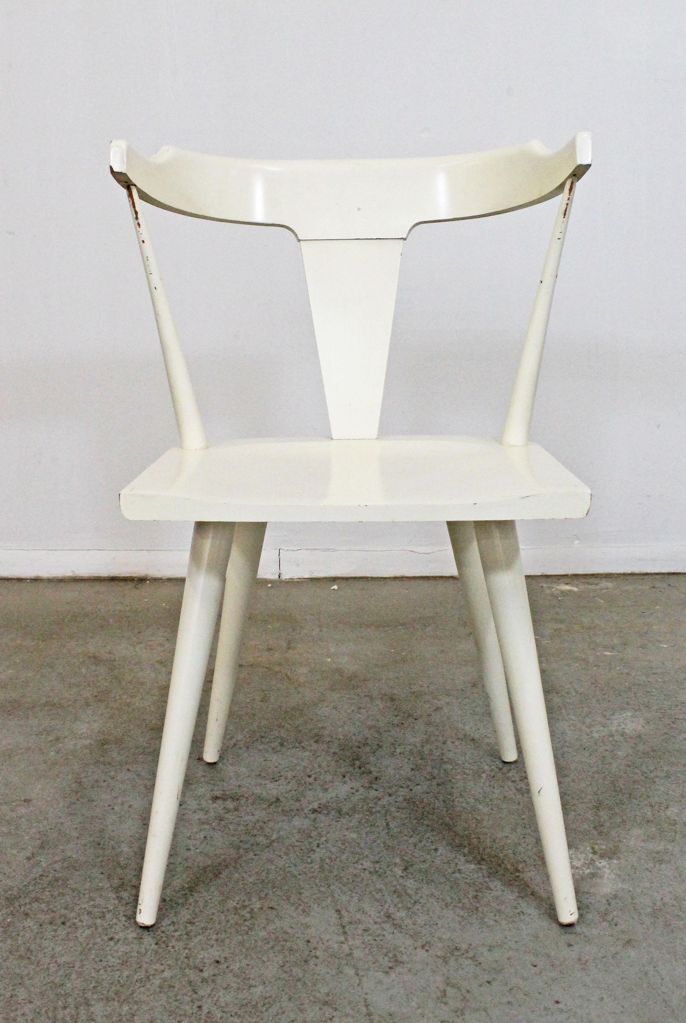 Offered is a vintage side chair designed by Paul McCobb for Planner Group. It is in good condition with some age wear including paint chips, surface scratches, and slight stains. We believe it was painted by its previous owner. It is marked by Paul
