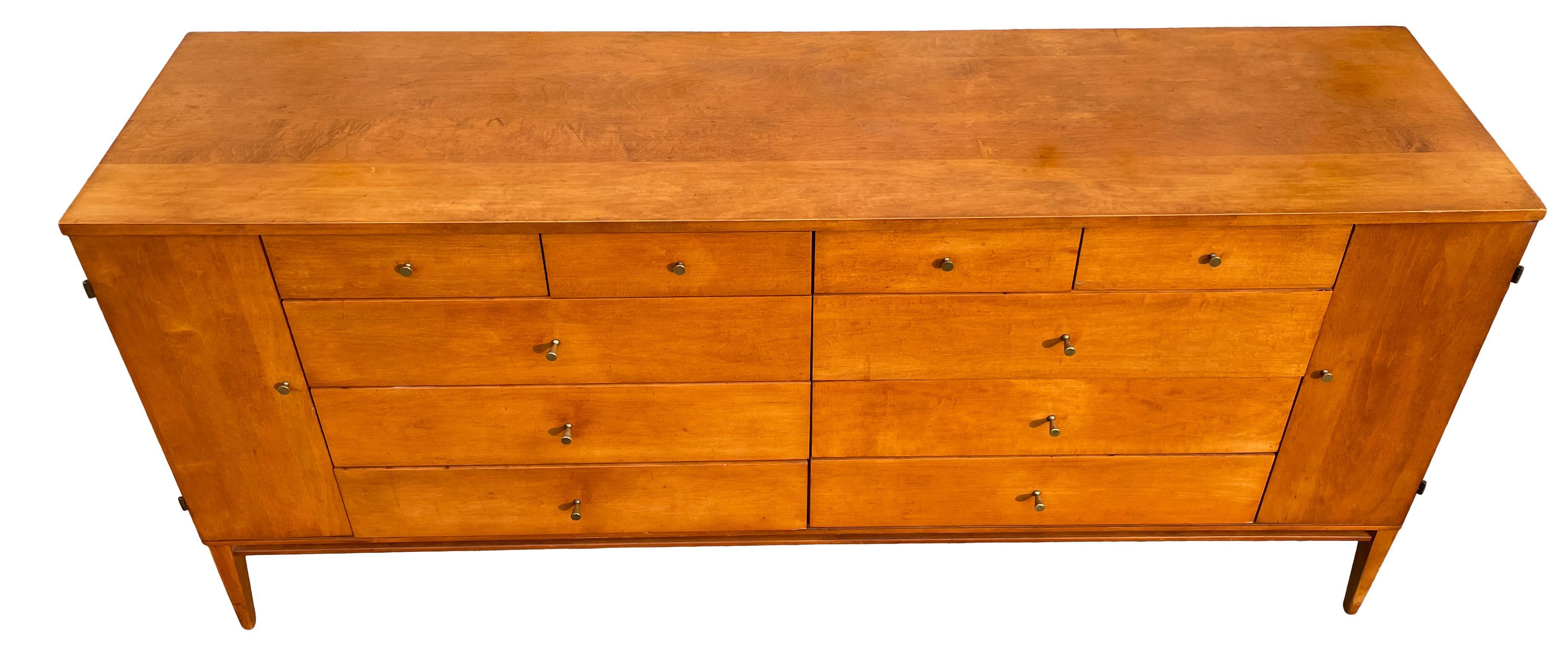 Mid century American Designer Paul McCobb Maple 20-drawer dresser #1510 Tobacco finish Brass Pulls. Original patina finish in vintage condition - Has original brass Pulls - All solid maple with a Light Tobacco finish - Minimalist wood standard base