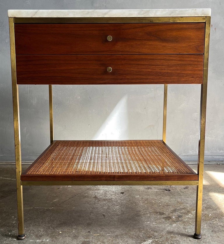 Beautiful Paul McCobb rare Single Nightstand /bedside table. The Irwin Collection by Calvin. Walnut case piece topped with Carrara Marble on a brass base featuring two drawers and a lower cane shelf. In wonderful original condition showing nice