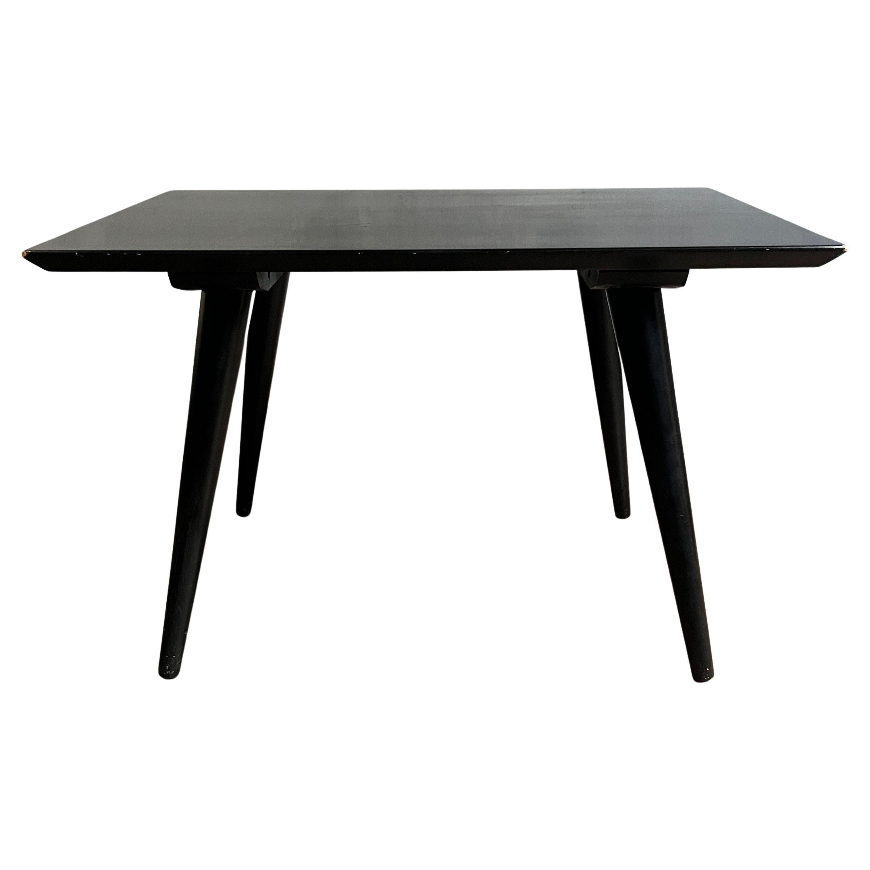 Beautiful Paul McCobb Planner Group #1546 solid maple side table or small coffee table with original heavy black lacquer finish with nice patina. Very delicate designed coffee table with tapered legs - All legs unscrew just fine. All solid maple.