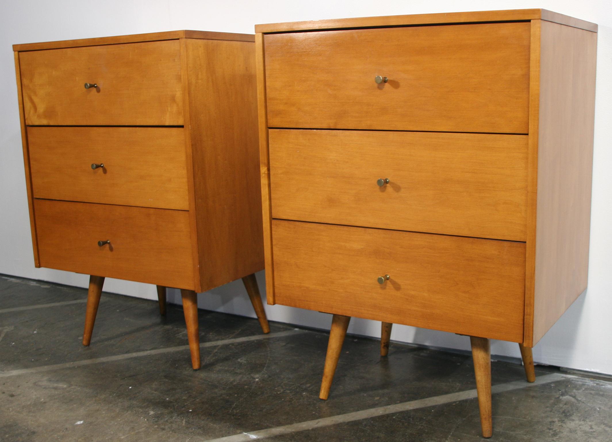 Beautiful clean pair of Paul McCobb Planner Group #1506 maple nightstands end tables triple-drawer. Original brass cone pull knobs. Refinished in blonde maple professionally sprayed. Very modern designed pair of nightstands with 4 tapered solid