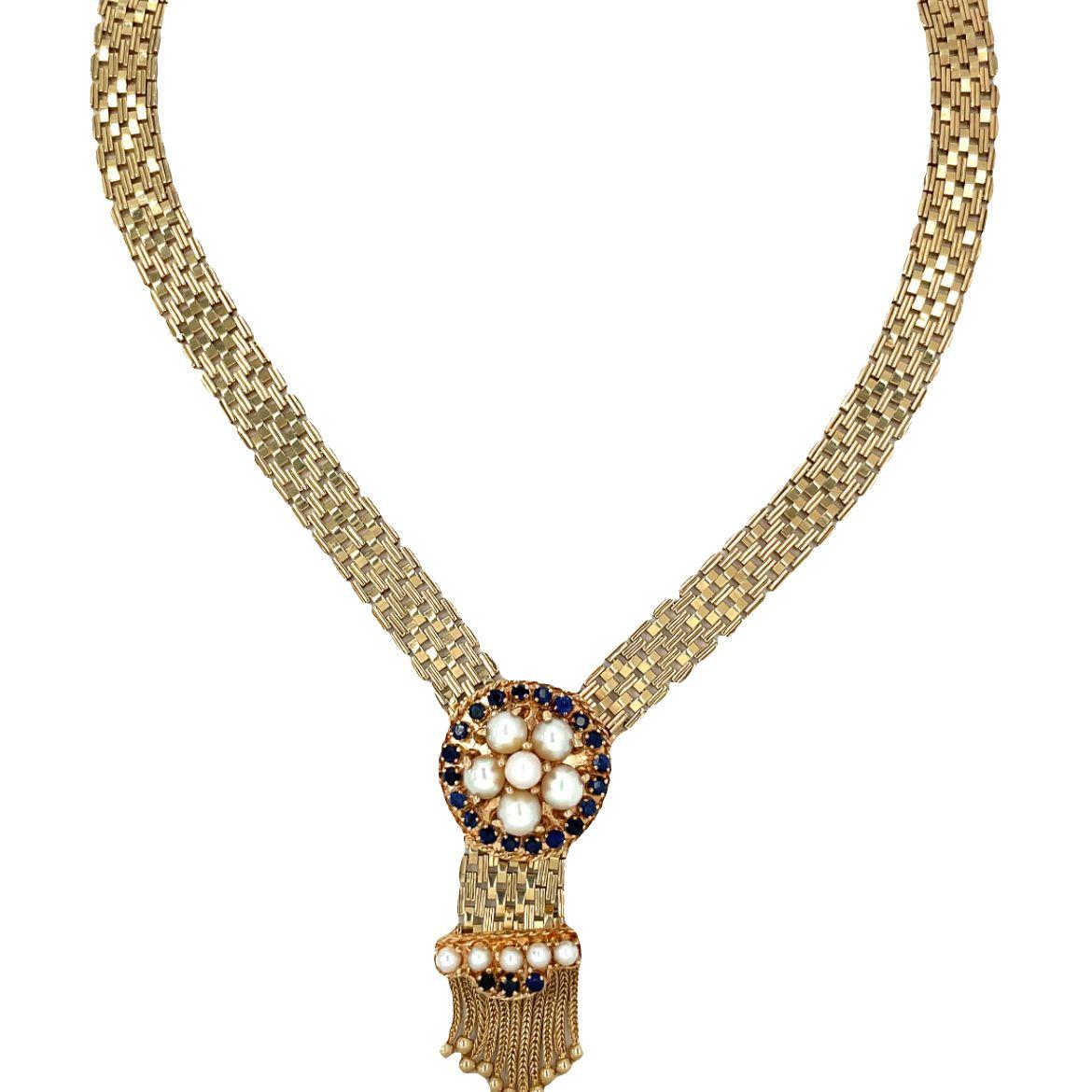 This elegant 14K yellow gold necklace features a stunning combination of pearls and blue sapphires. The center of the necklace is adorned with six round cultured saltwater pearls, beautifully surrounded by 20 prong-set round mixed-cut natural blue