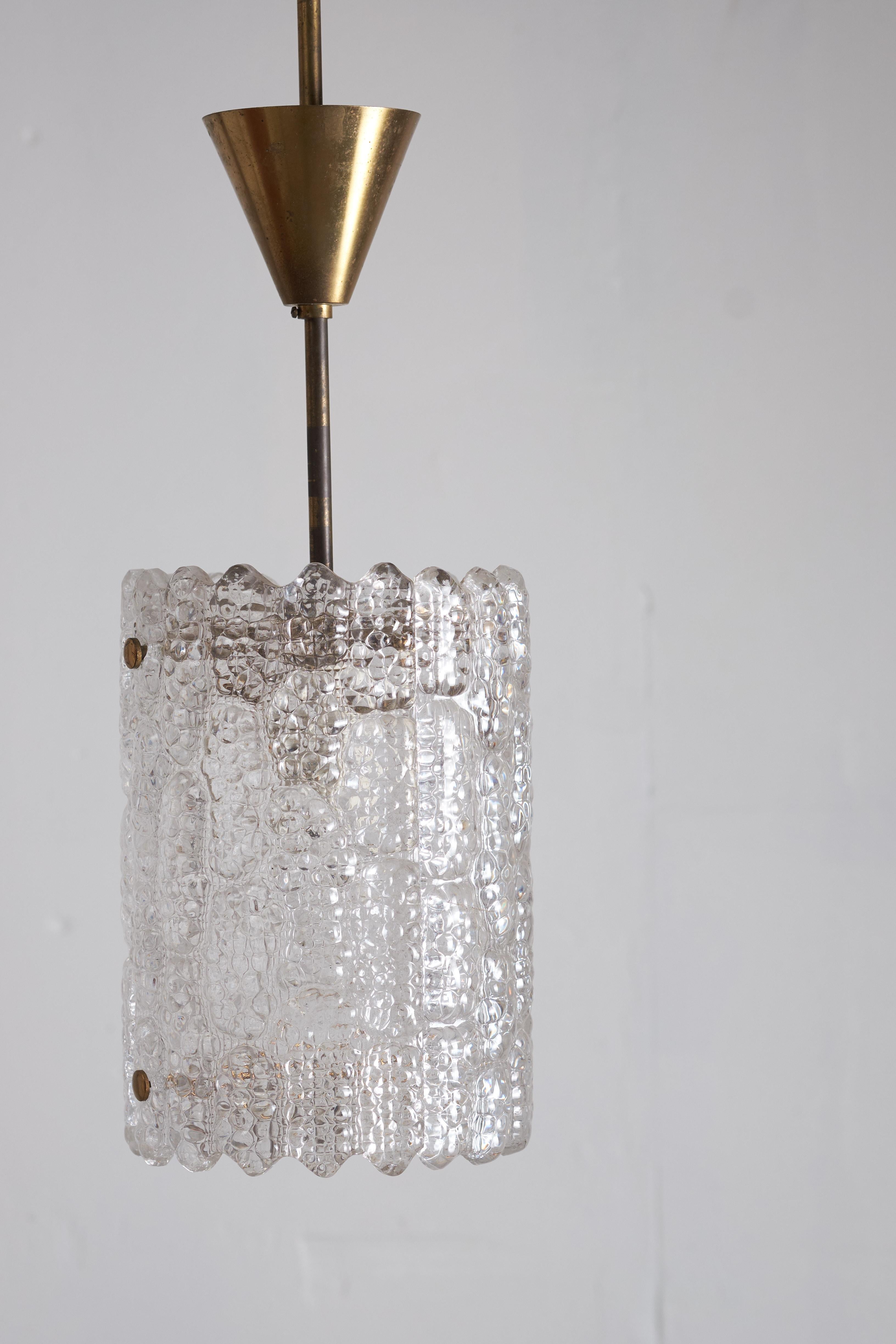 Pendant designed by Carl Fagerlund for Orrefors, Sweden, 1960s. This stunning lamp is made of brass with crystal glass as shade, which provides a nice a warm light. The lamp is in a very good condition with no chips in the glass.
A pendant which is