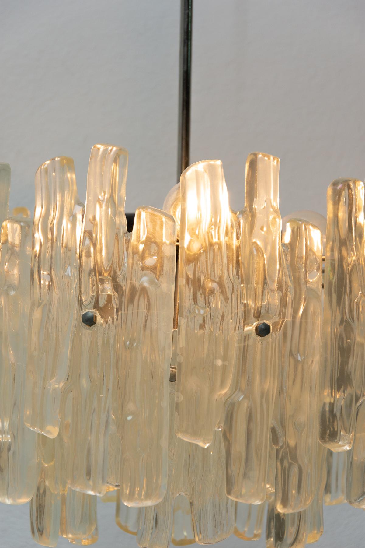 Midcentury Austrian chandelier probably designed by Julius Theodore Kalmar and made in the 1960s in Austria. This spectacular chandelier features imitation of icicle-like glass components that make up the shade. It features three light bulbs E14.