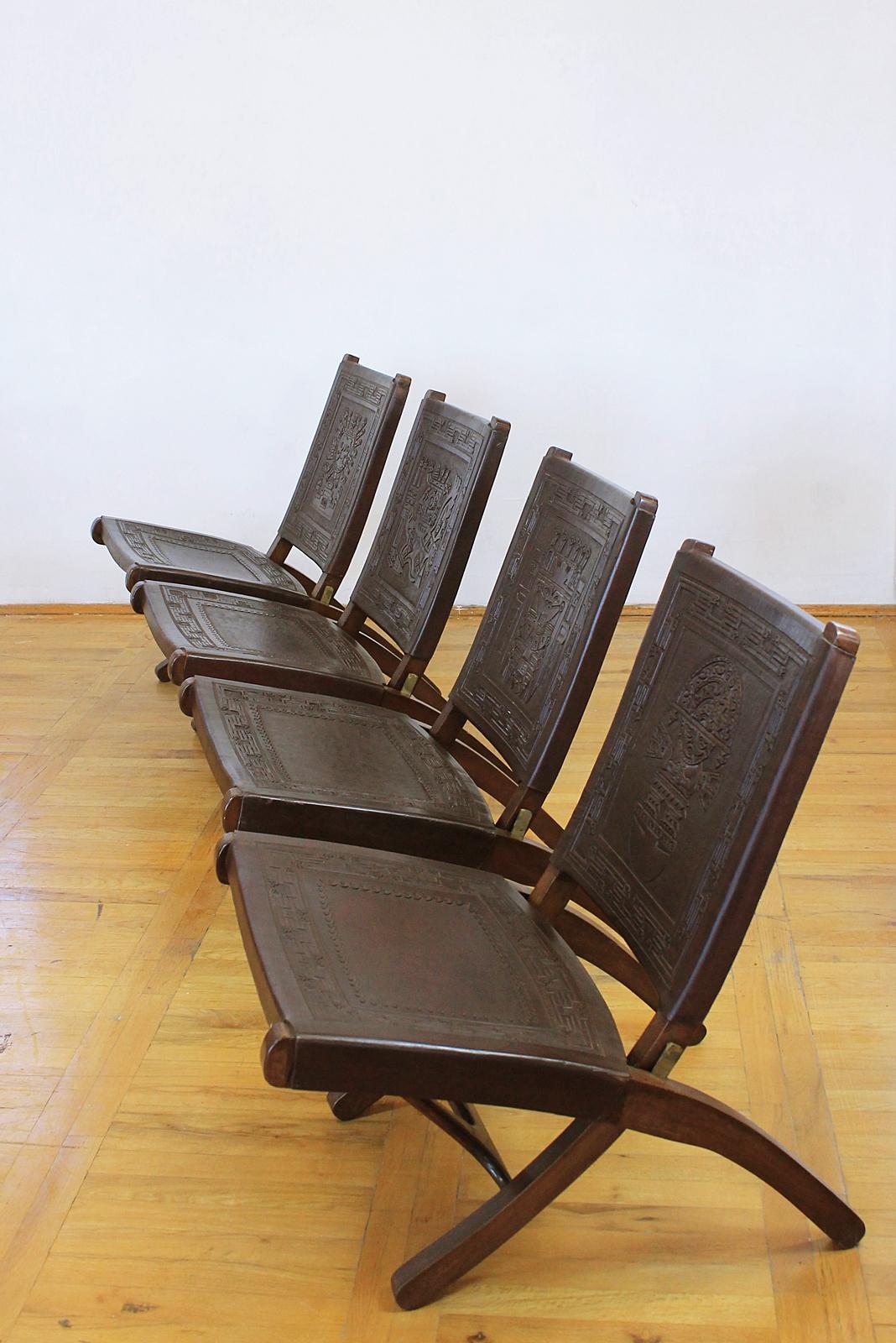 4 Peruvian leather chairs having seat and each has a different Peruvian figure hand tooled into leather backrest. All on solid wood frame with brass folding mechanism.
 
Condition: Wear consistent with age and use.

Priced per chair.


 
