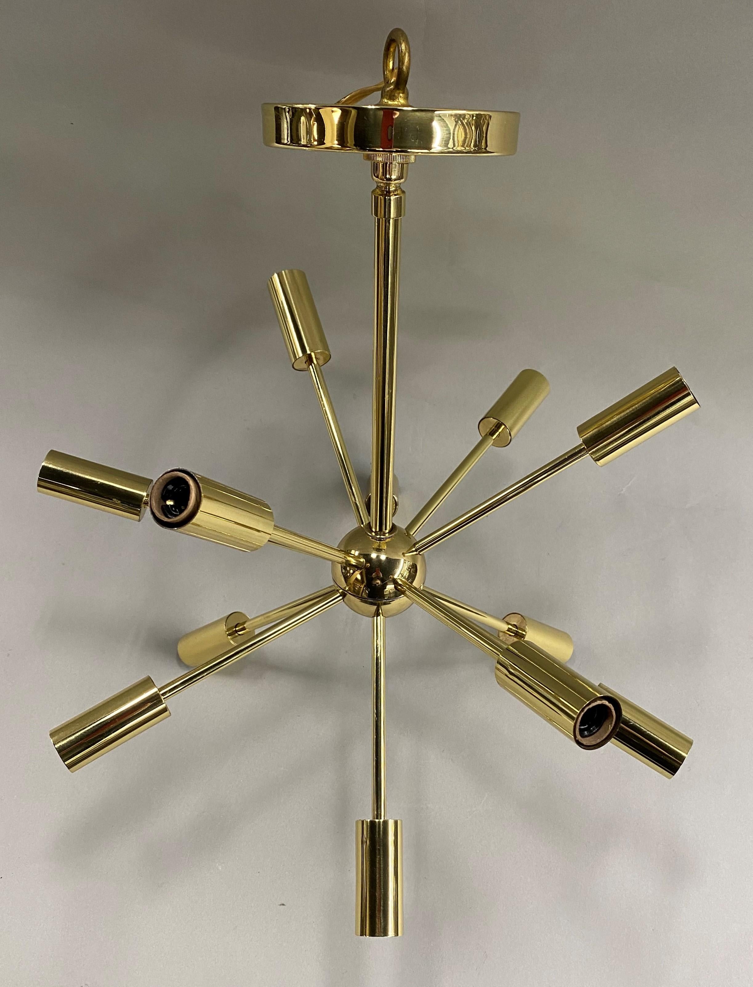 A fine mid-century space age design petite Sputnick 12-light brass chandelier with canopy. The first satellite that ever orbited the earth was the Soviet Union's Sputnik satellite, launched in 1957. Soon thereafter the launch inspired the creation