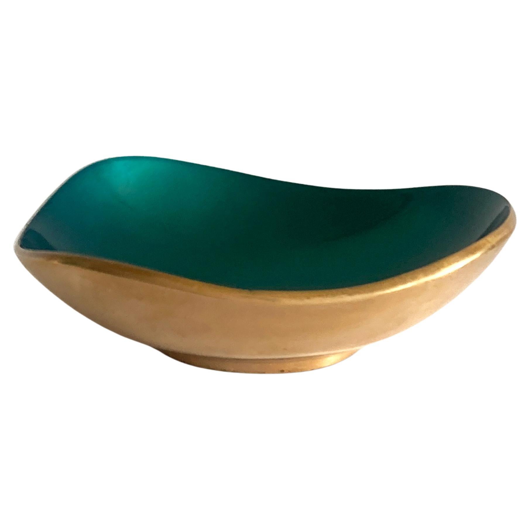 Striking brass and green enameled petite bowl, 1960s. The brass contrasts beautifully with the green enameled interior, this piece is stunning at different angles. Has a nice weight to it. Would look wonderful on a side table or dresser.

In good