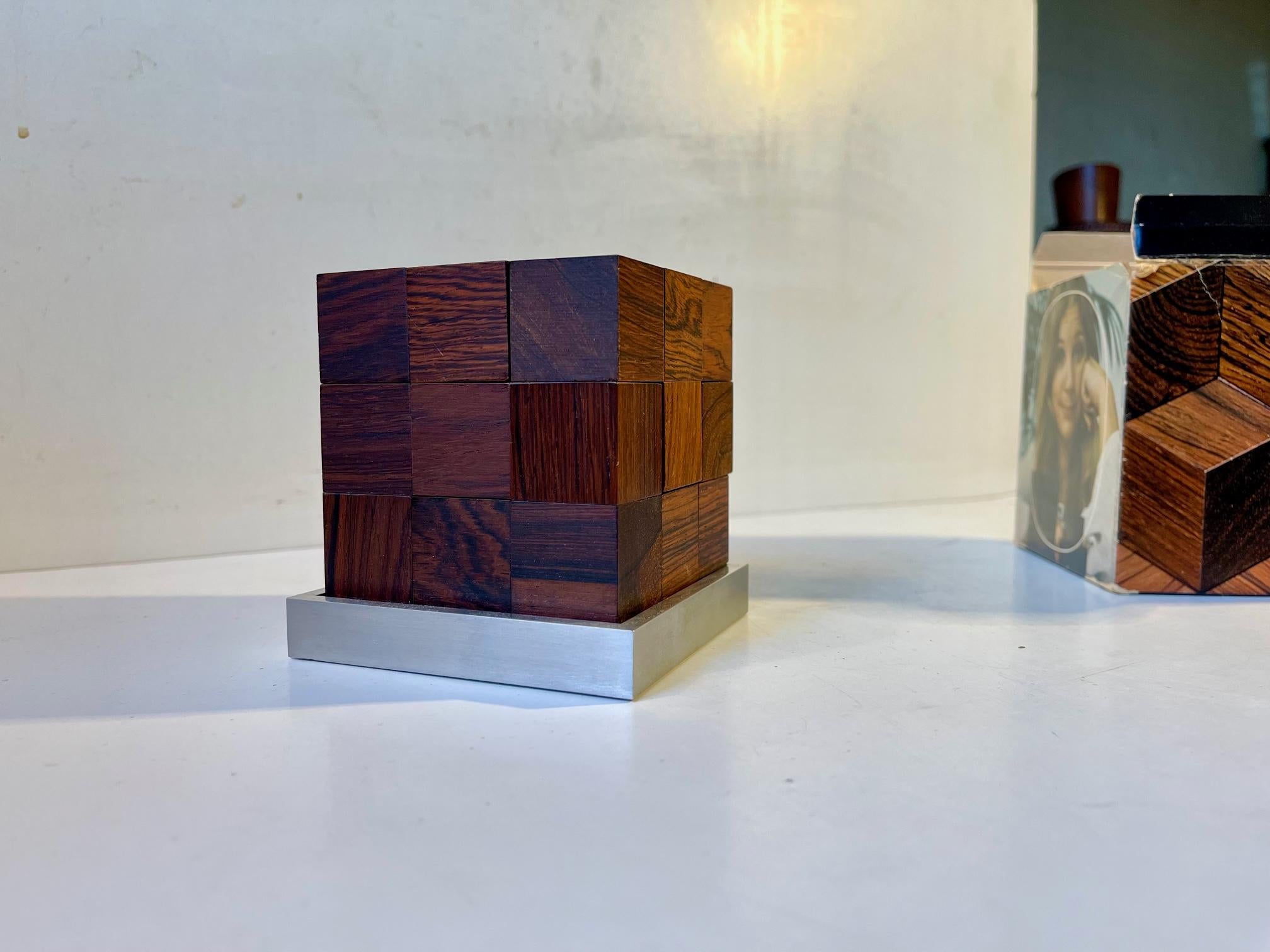 A rare Advanced Cube Puzzle designed by Piet Hein (1905-1996) in the late 1950s and manufactured by Skjode in Skjern, Denmark, during the 1960s. It is called soma and is executed in Rosewood, Wenge wood and aluminium. It comes in its original box