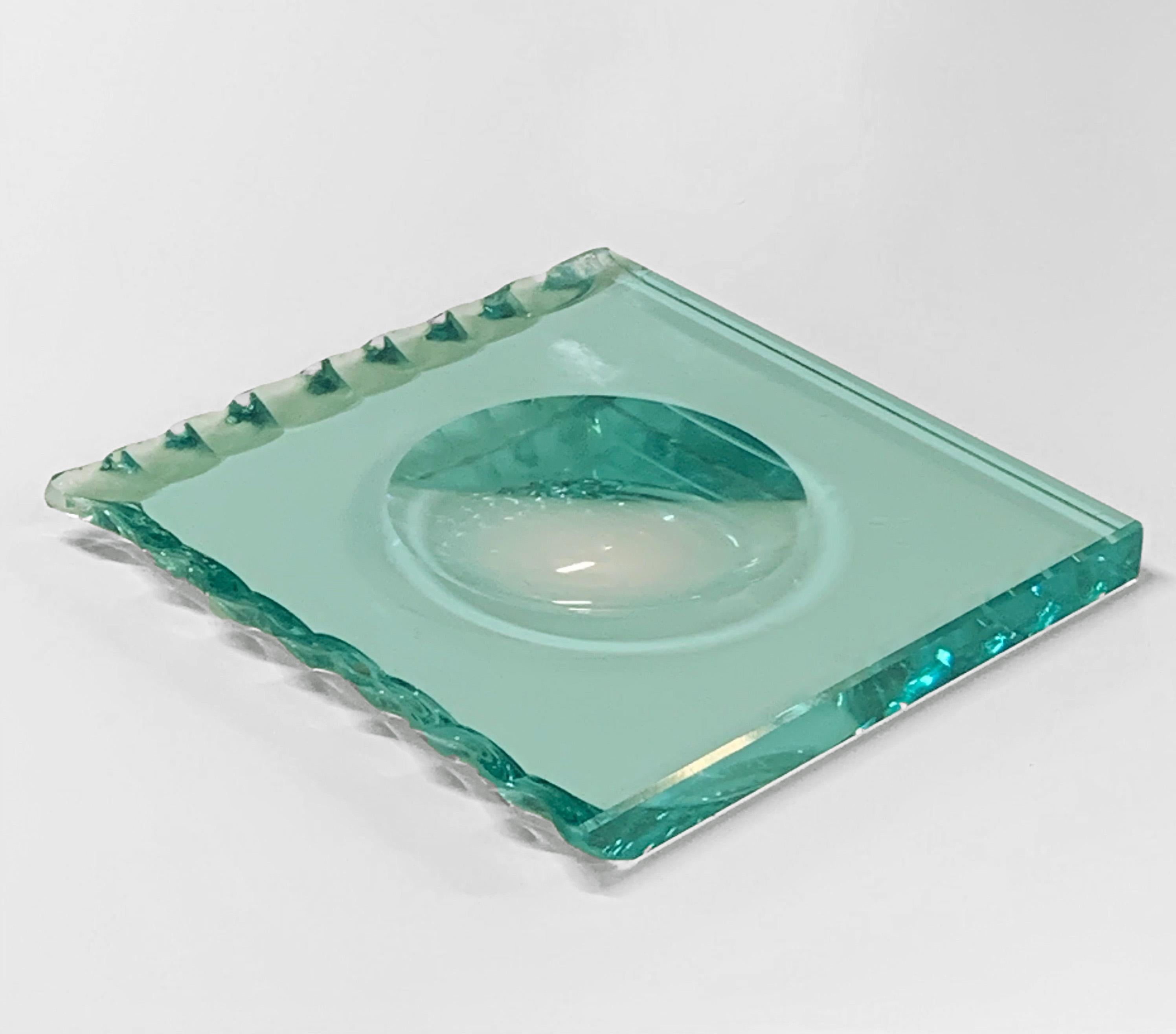 Amazing midcentury carved crystal glass ashtray. This wonderful item was designed by Pietro Chiesa for Fontana Arte in Italy during 1960s.

This piece is unique as it has two carved sides and two straight ones and tone of the crystal, that is a