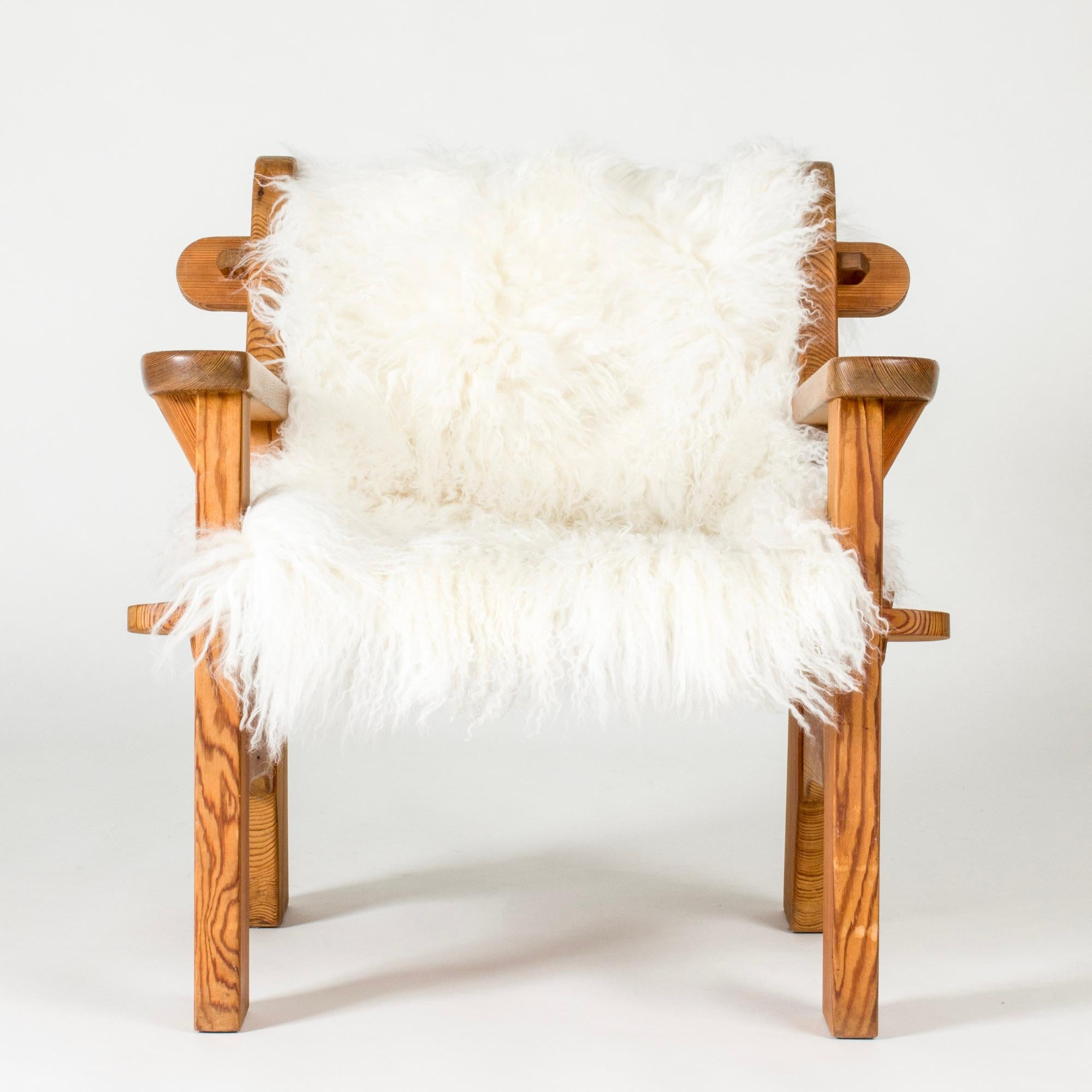 Lounge chair by David Rosén, made from pine in a chunky, rustic design. Rounded details, lovely woodgrain. Comes with a loose sheepskin.