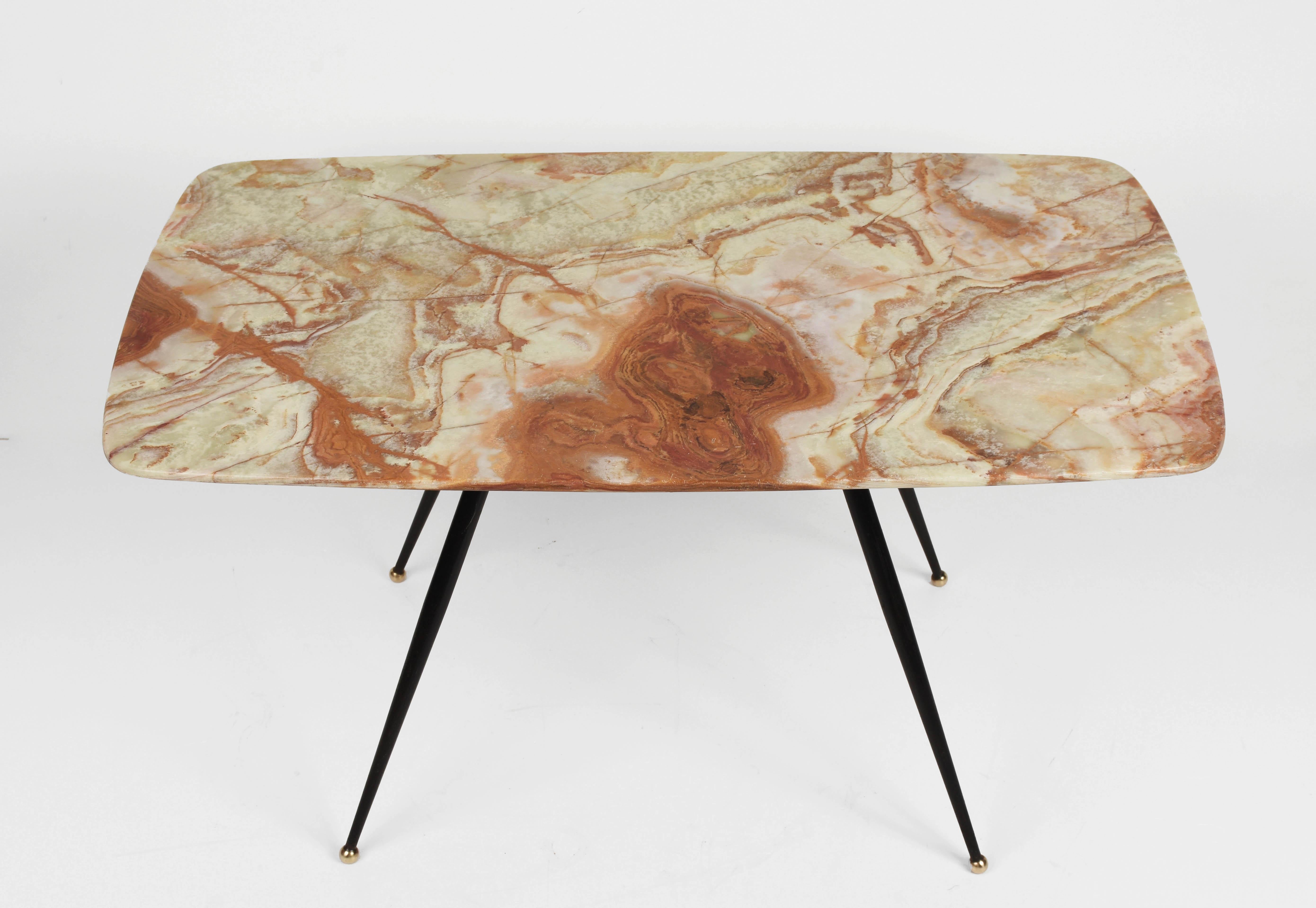 Beautiful and unique midcentury pink and green onyx marble coffee table with brass feet. This amazing piece was produced in Italy during 1950s.

This piece is fantastic as the marble top has the Classic shape the Italian design of the 1950s. The
