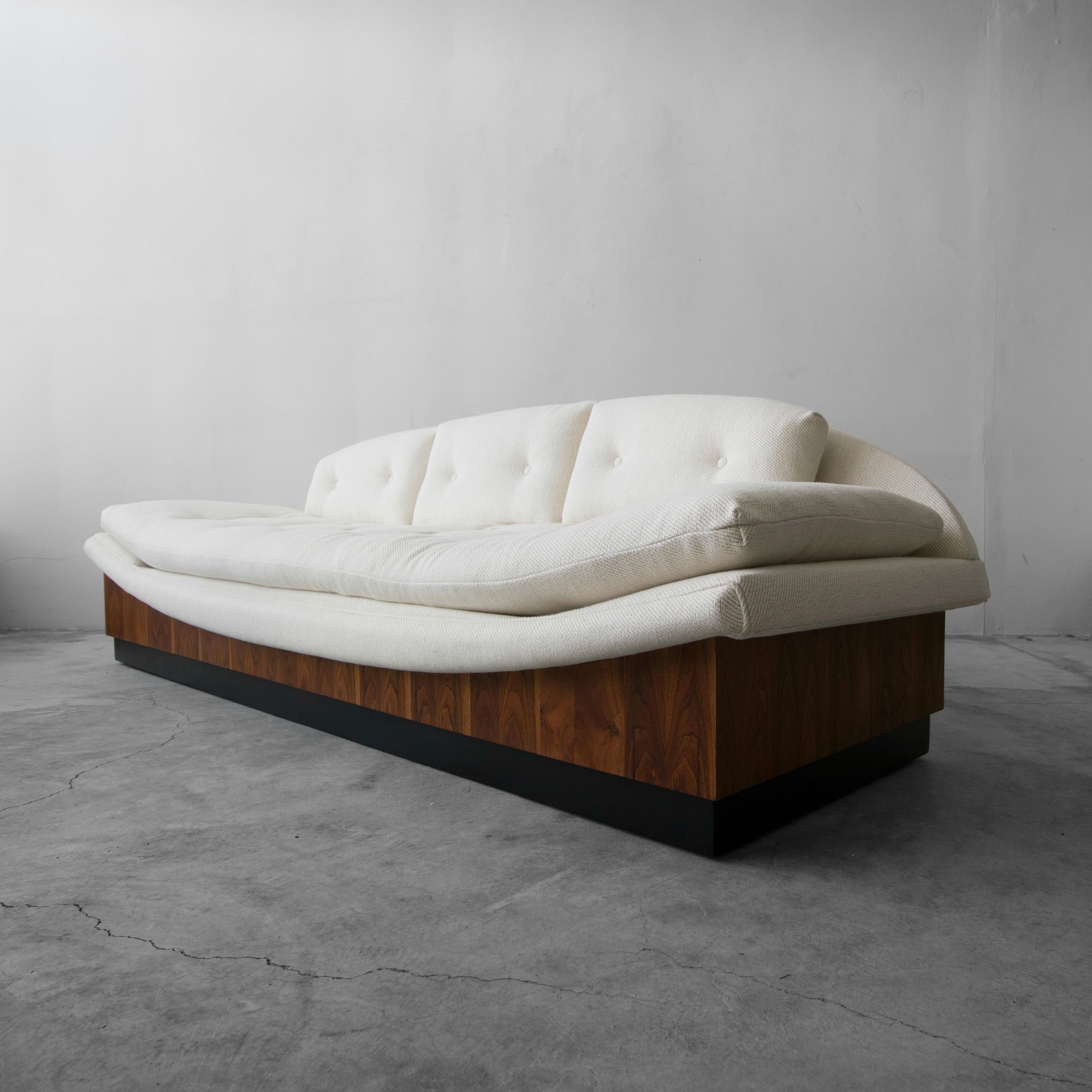 Absolutely stunning floating midcentury gondola sofa by Adrian Pearsall for Craft Associates. Amazing lines and details make it a real show stopper. It measures 9ft in length and is supported by a beautifully grained walnut platform that sits on a