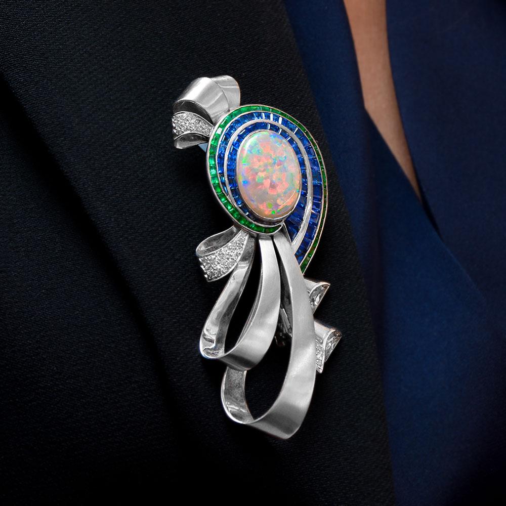 Oval Cut Midcentury Platinum Brooch with Opal, Diamonds, Emeralds, and Blue Sapphires For Sale