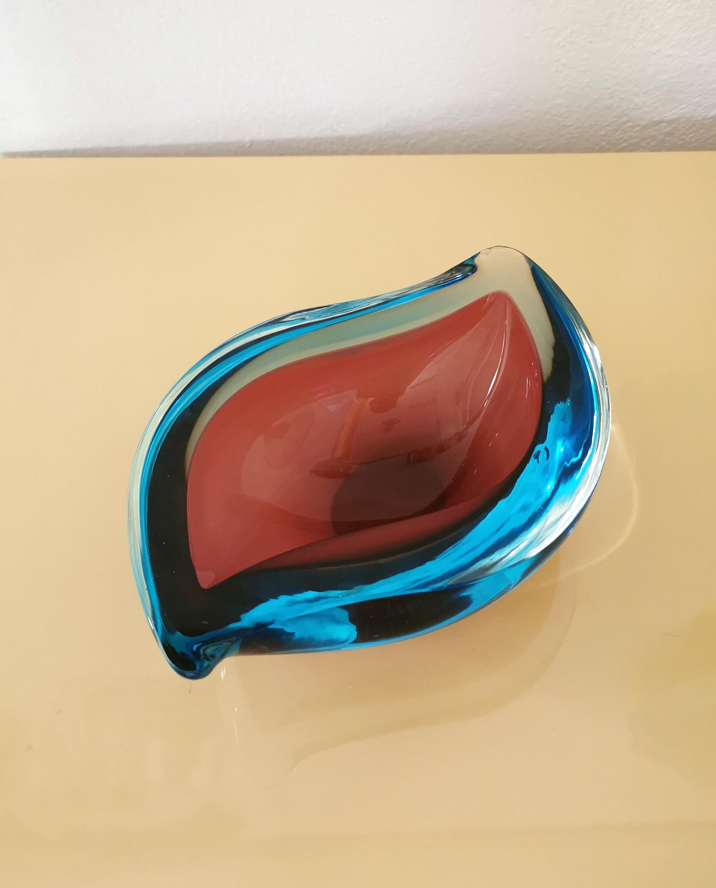 Vide-poche/ashtray with the particular shape of a drop attributable to the Italian designer Flavio Poli, produced in the 70s.
The vide-poche was made of Murano glass, in shades of bordeaux and light blue with the famous 