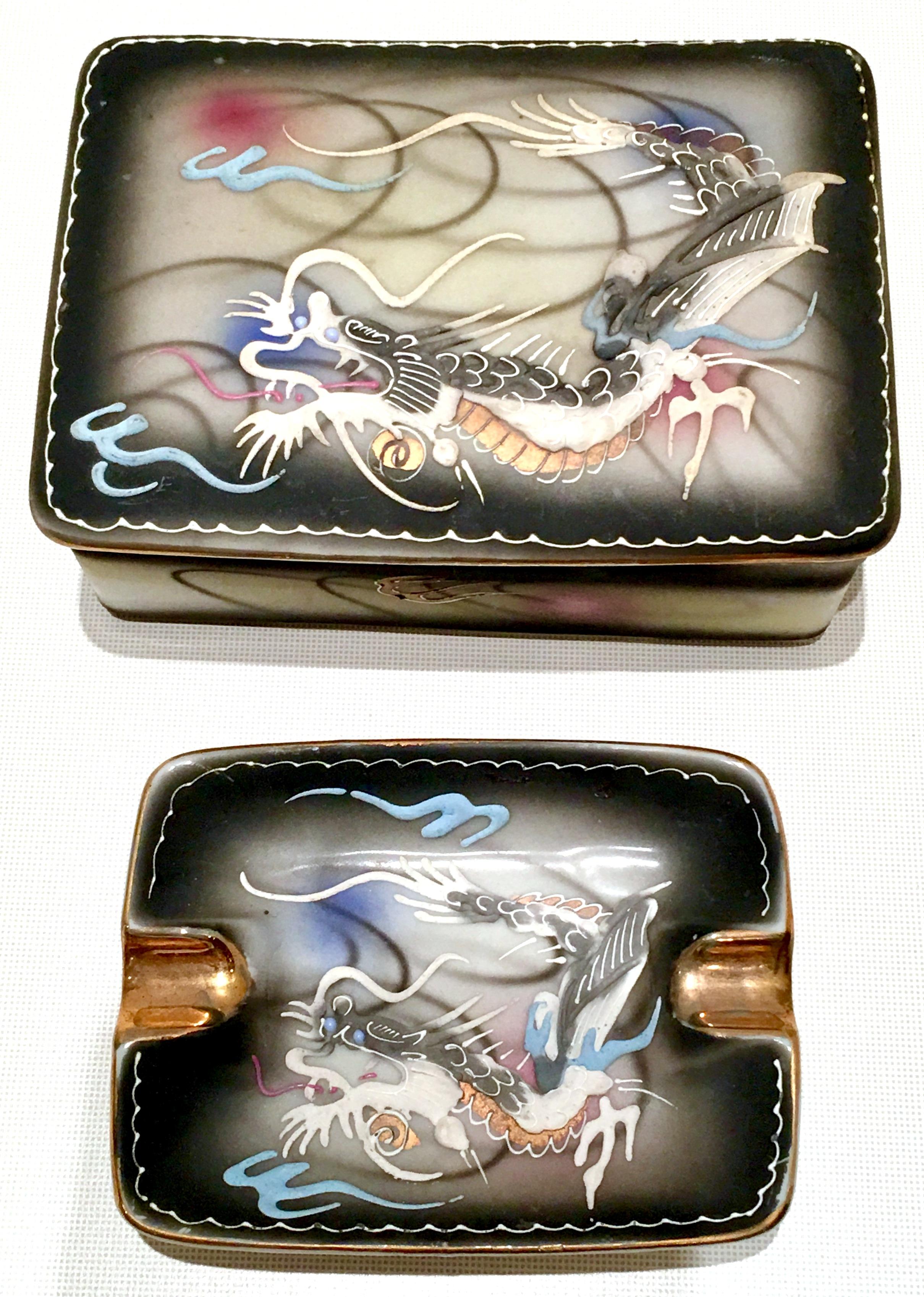 Japanese hand-painted moriage dragonware three-piece smoking set. Includes one footed box with lid and one ashtray with 22-karat gold detail.
Ashtray measures, 4.5