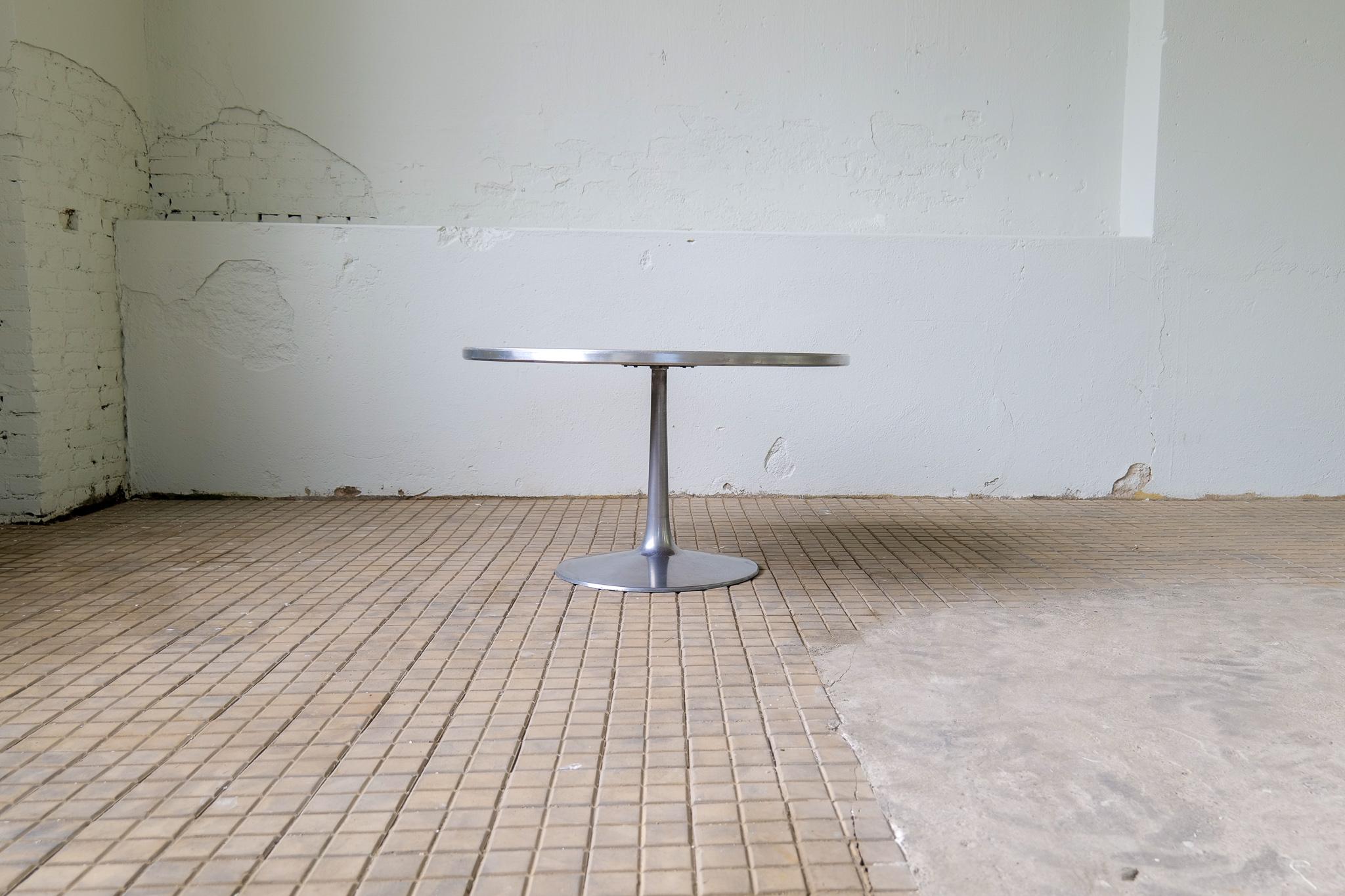 A beautiful dining or center table with a rosewood sequence matched veneer top in a radiating pattern around an inlet aluminum circle, with aluminum trim and aluminum pedestal extending into a round base.
Designed by Steen Ostergaard for Poul