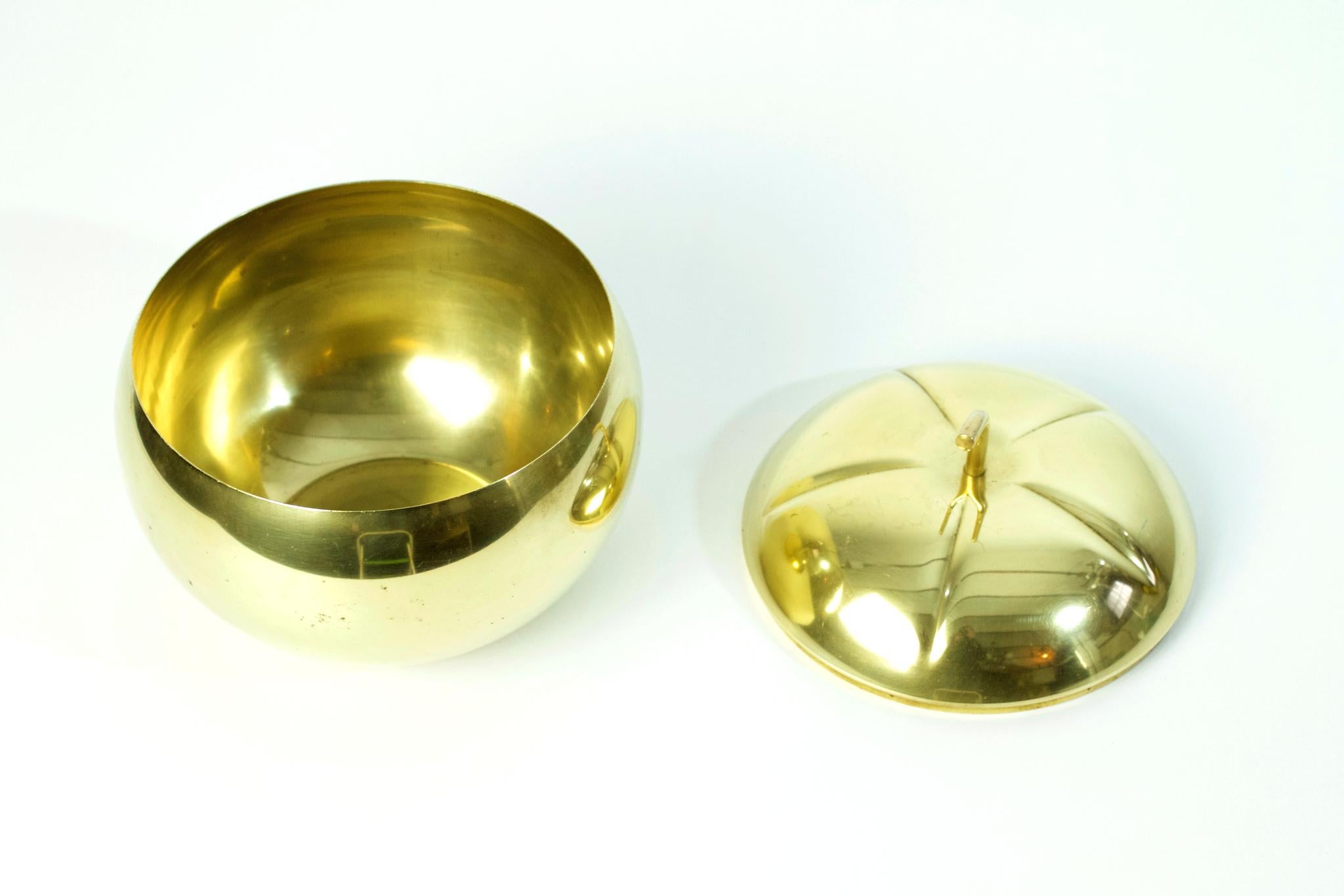 A large handcrafted ice bucket or bowl in the shape of a pumpkin in brass.