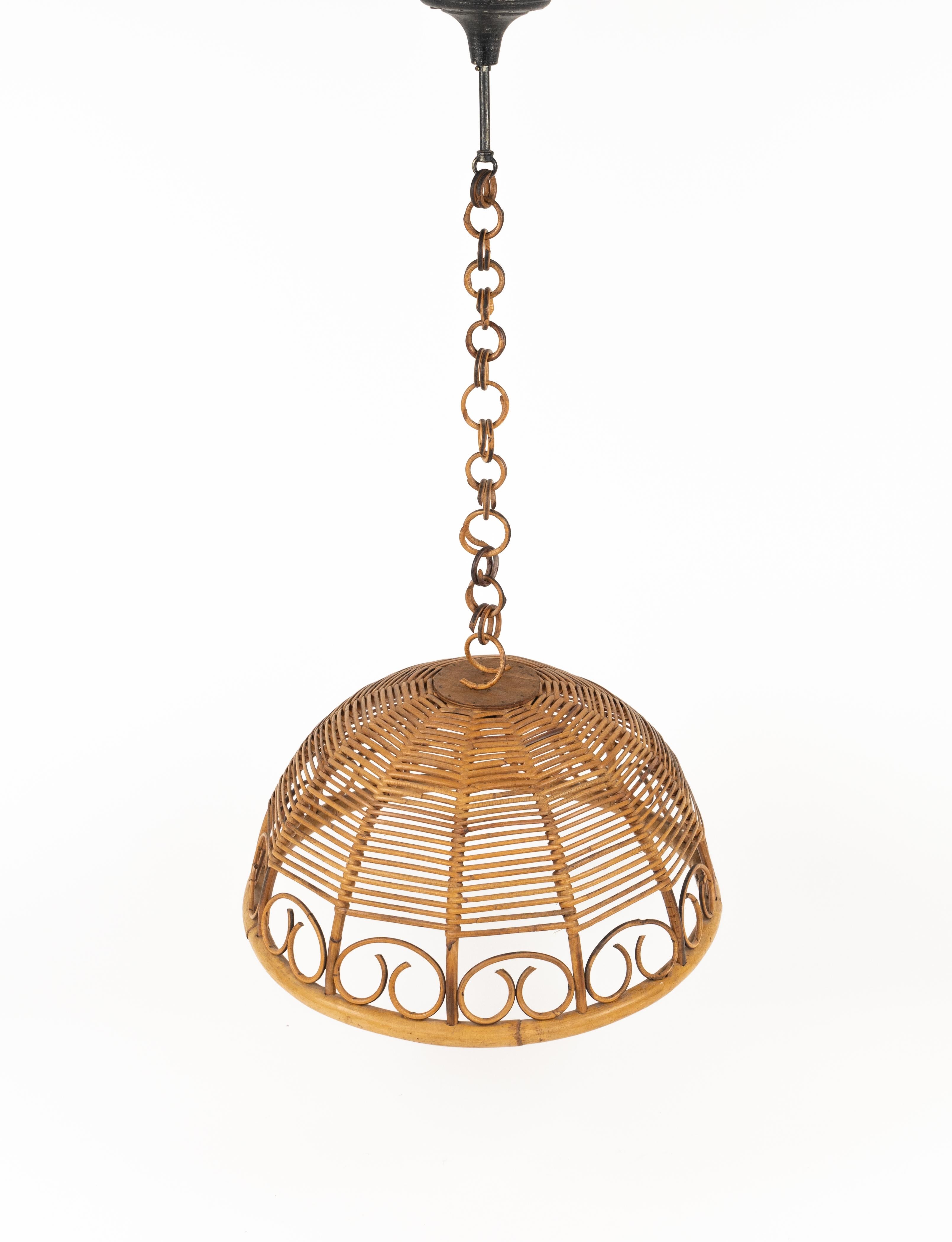 Midcentury beautiful handcrafted chandelier in rattan and bamboo with chain in rattan.

Made in Italy in the 1960s.  

It will be gorgeous hanging over a kitchen's table or dining area but also placed in a bedroom or bathroom to add a fresh