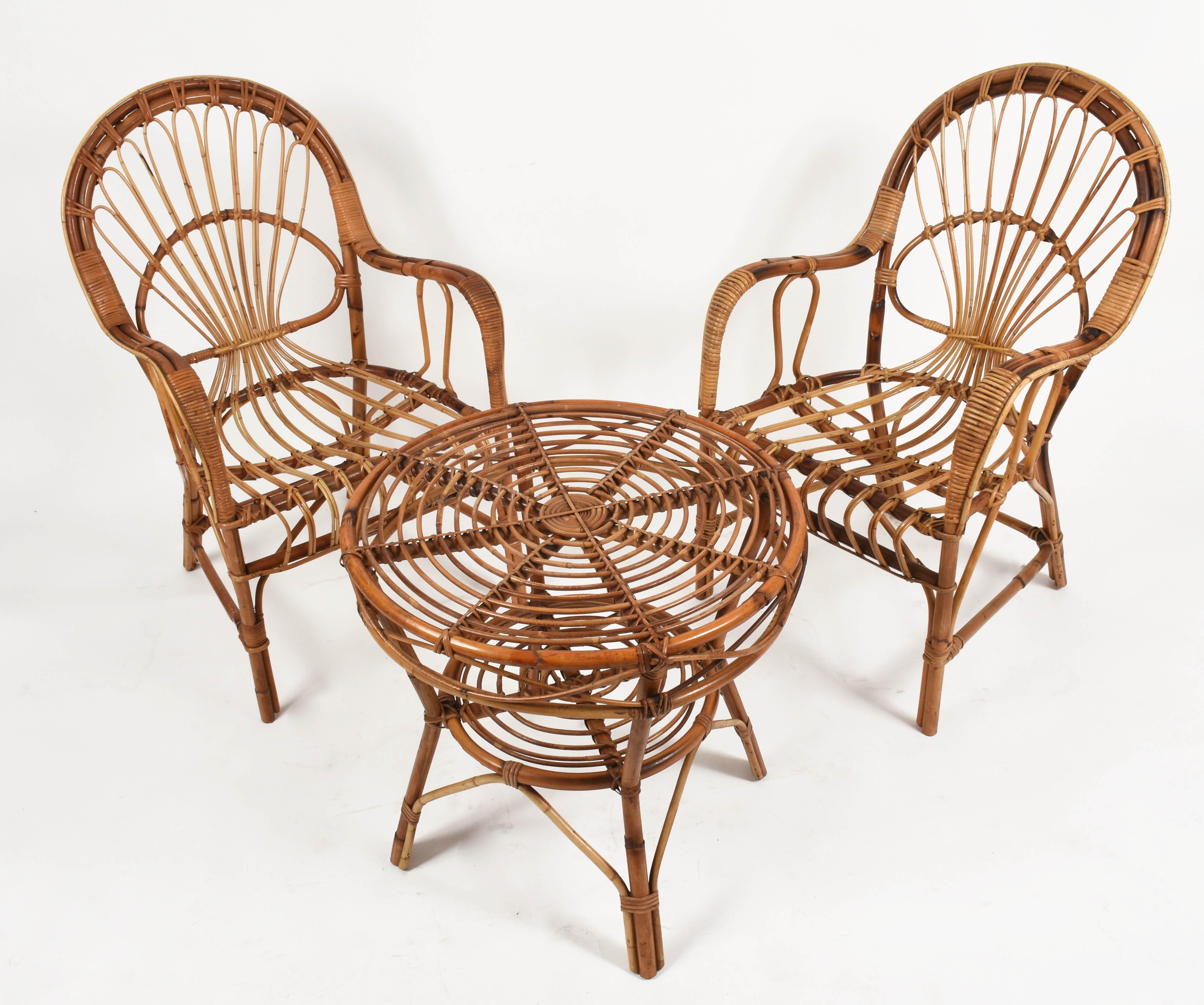 Midcentury rattan and bamboo set, made of two armchairs and coffee table.

This iconic Italian set is a 1970s production.

The structure is in excellent condition and is very sturdy, making these items ideal for both indoor and outdoor use.

 