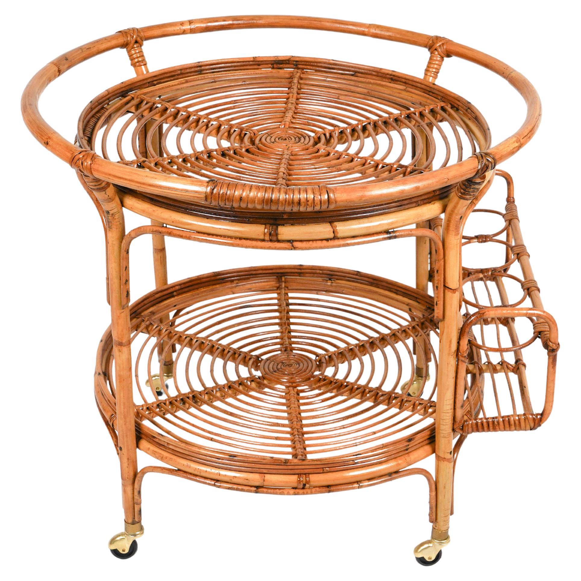 Amazing round serving bar cart in bamboo & rattan structure featuring two shelves. 

The upper one is framed by a bamboo handle and the lower one features four bottle holders mounted externally. 

Made in Italy in the 1960s.

Bamboo / rattan has