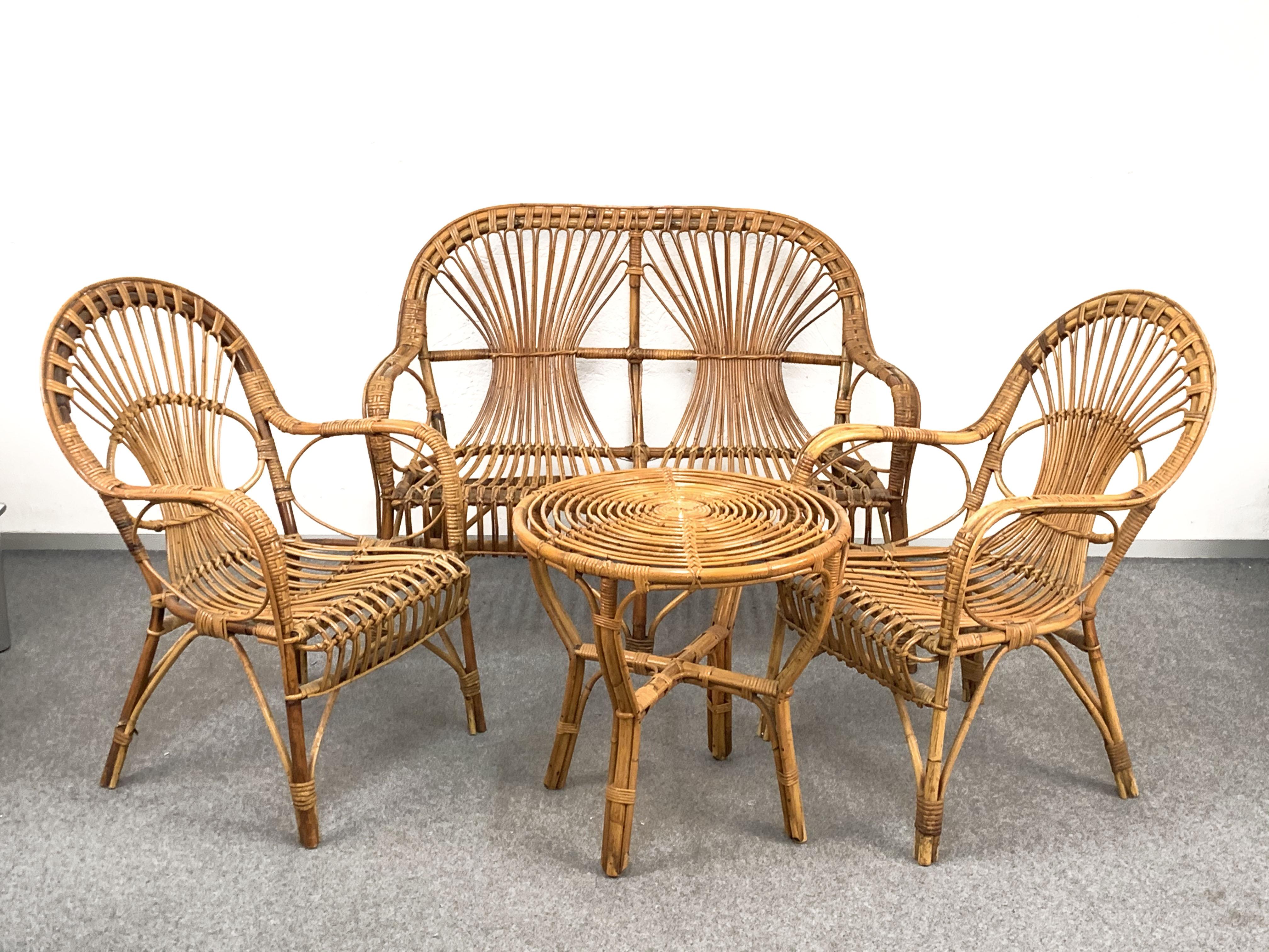 Iconic Italian set attributable produced in Italy during 1960s.

This midcentury set is made of a double seat sofa, two armchairs and a coffee table in rattan and bamboo.

The structure is in great condition and is very robust, making these