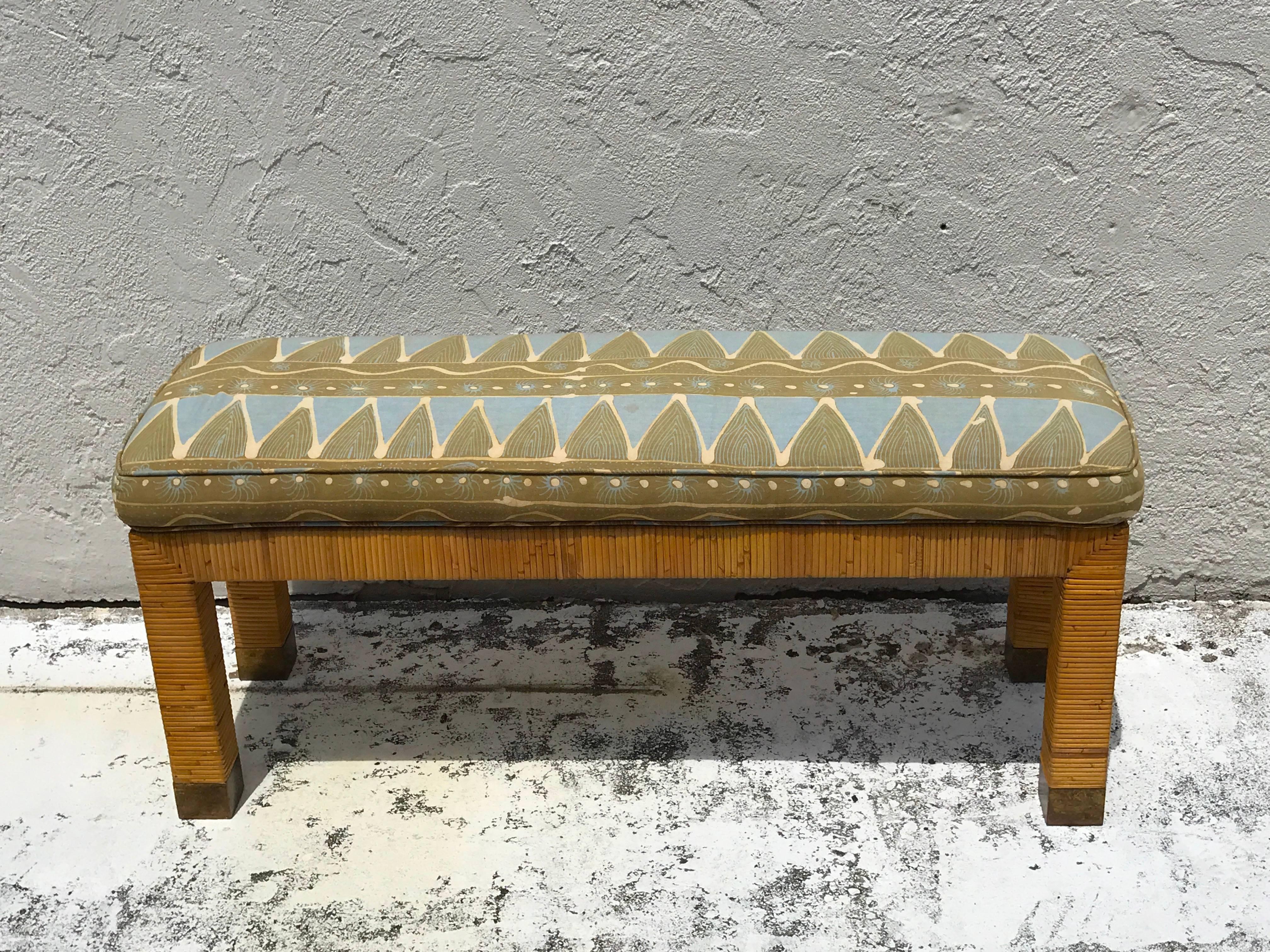 Midcentury rattan and reed long bench, fitted with brass end caps and upholstered seat cushion, ready for reupholstery in COM.
The bench without the cushion measures 42