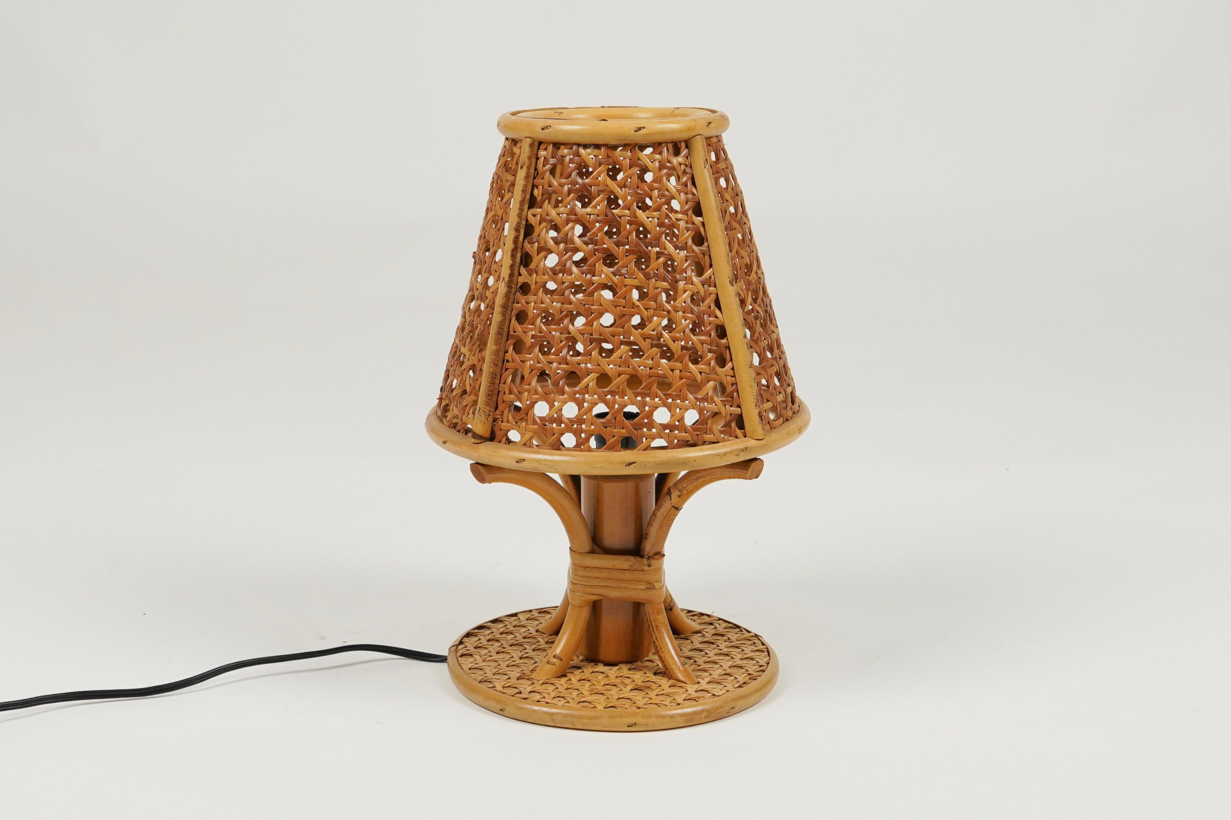 Beautiful table lamp in rattan and wicker in the style of Louis Sognot.   

Made in Italy in the 1970s.   

Louis Sognot was a French designer best known for his elegant furniture made from a combination of rattan and wood. Sognot was influenced by