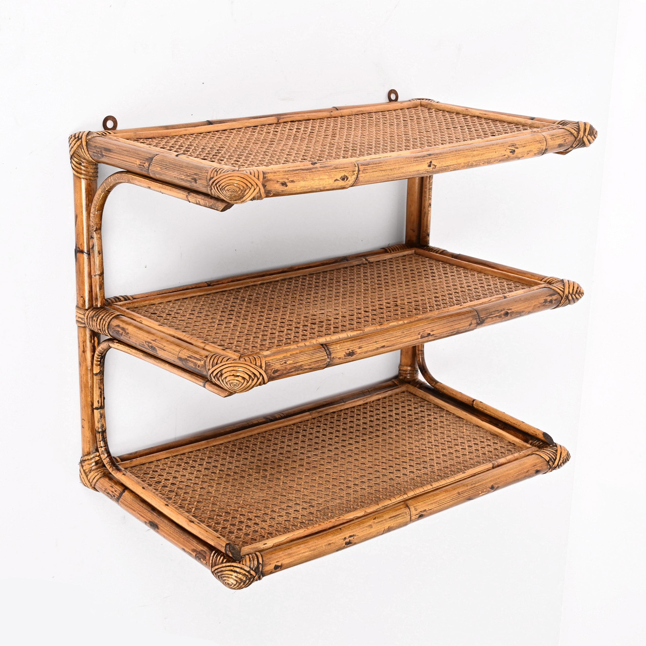 Stunning midcentury rattan, bamboo and vienna straw three-tier wall shelf. Vivai del Sud probably designed this amazing piece in Italy during the 1960s. 

This piece is unique as it comes with wooden shelves finished with Vienna straw, a