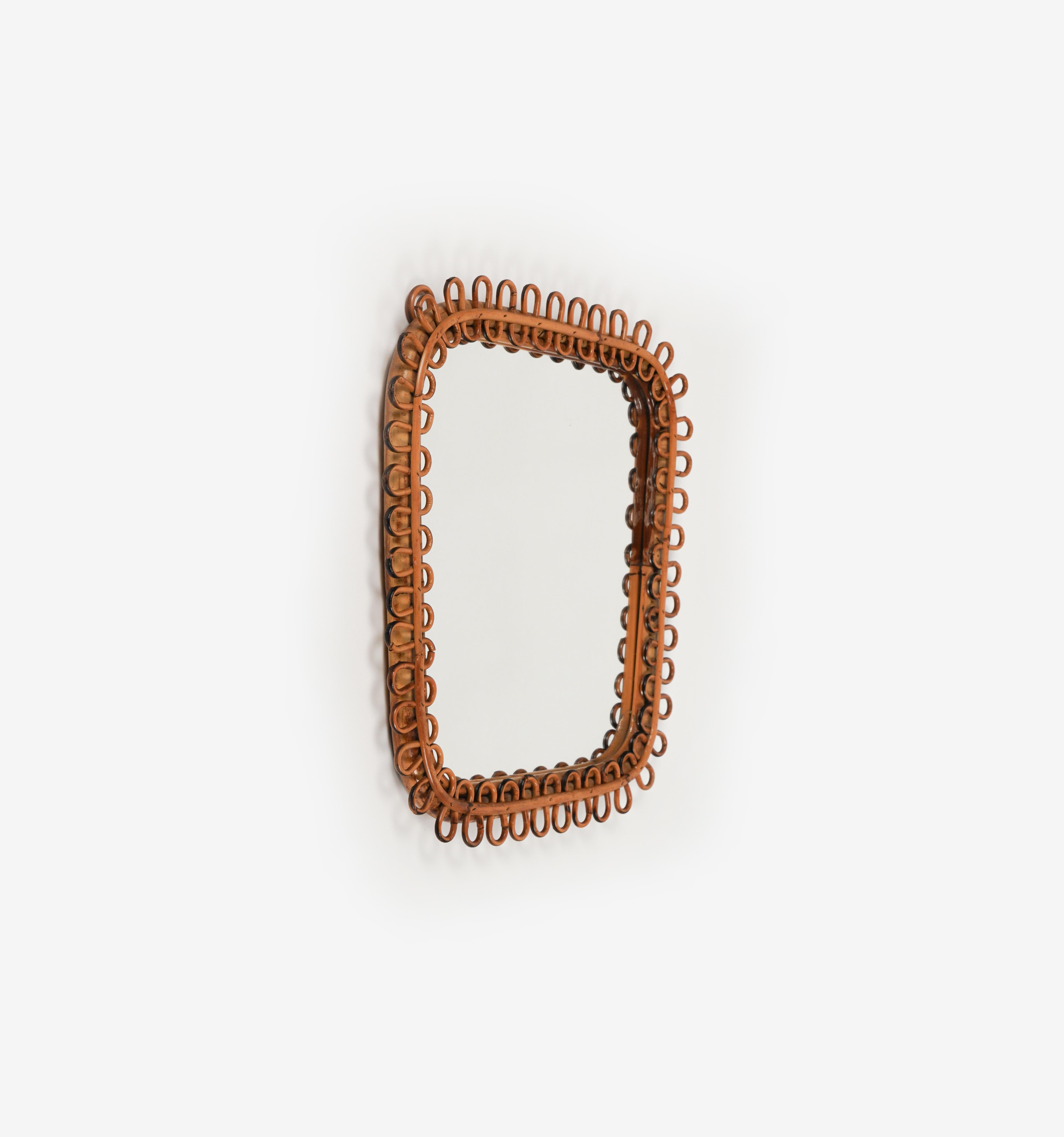 Midcentury beautiful square wall mirror framed by bamboo and rattan in the style of Franco Albini.

A highly decorative mirror with undulated rattan frame.

Made in Italy in the 1960s.

