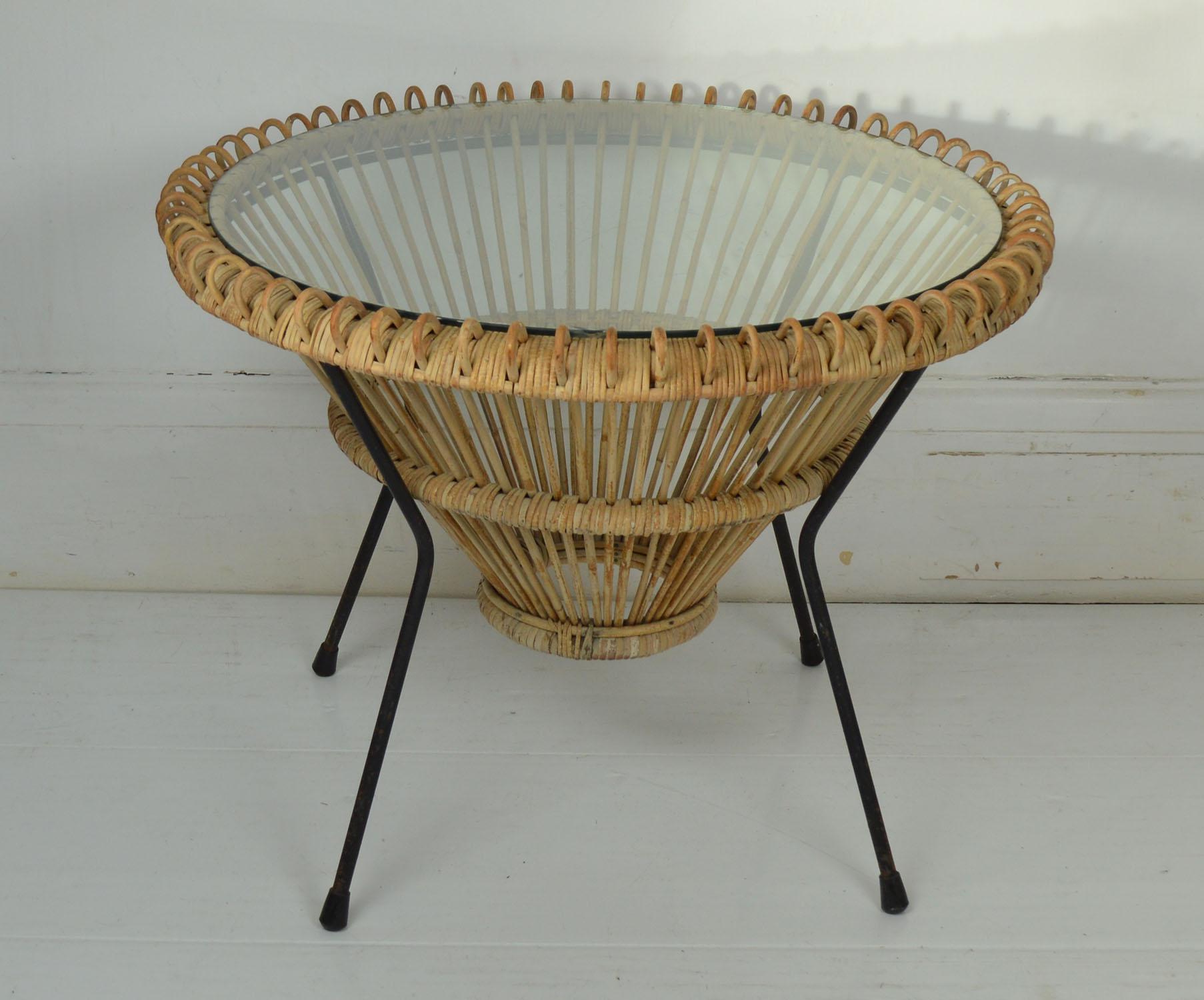 Very stylish coffee table.
 
Rattan and wrought iron.

No breaks to the rattan.

There is a slight chip to the edge of the original glass top so I have had a new one made.

 
