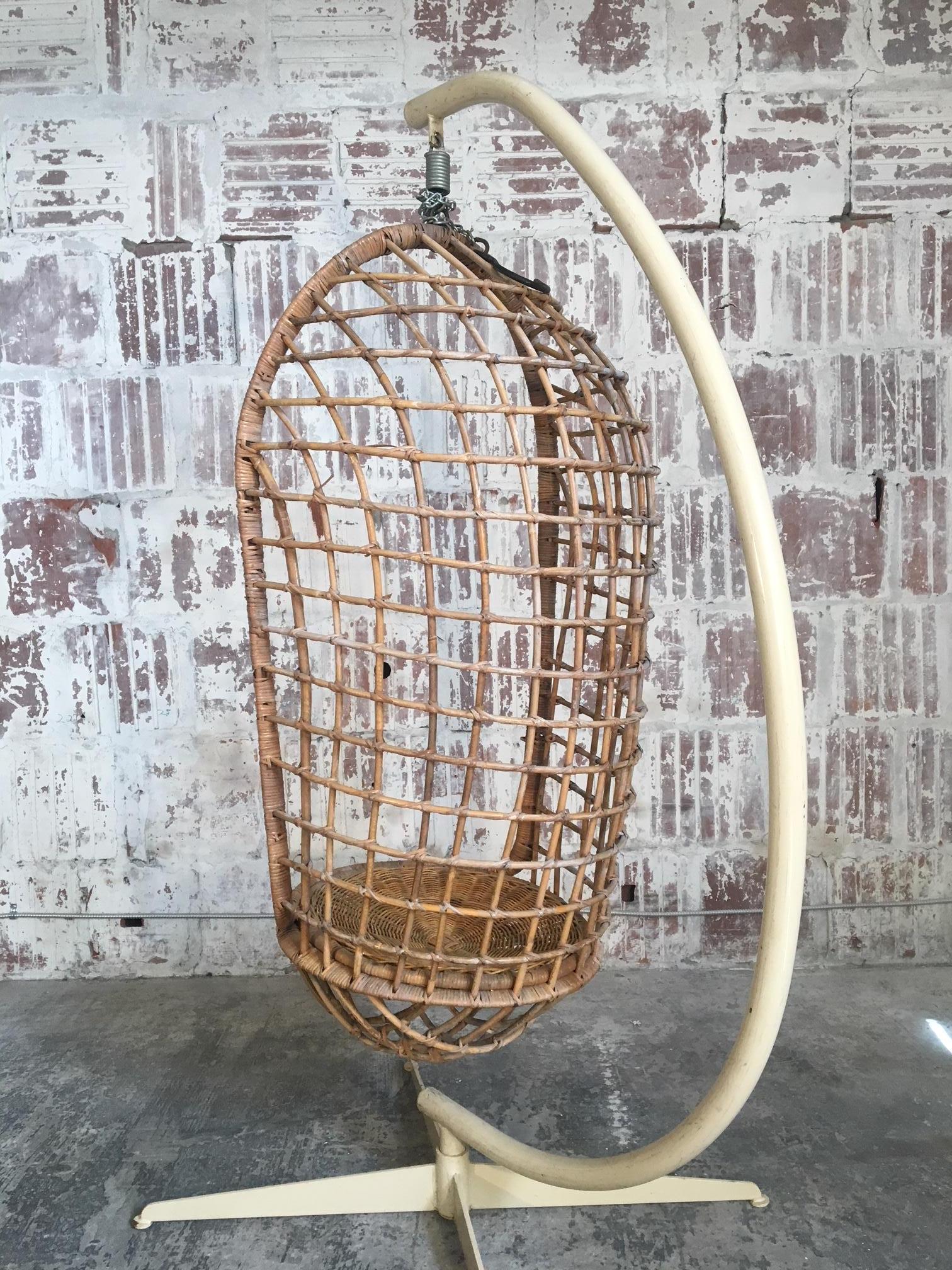 Vintage rattan hanging pod chair includes original steel stand. Also includes attached hook and chain for use without stand. Very good vintage condition with minor age-appropriate wear.
Chair alone measures 17.5