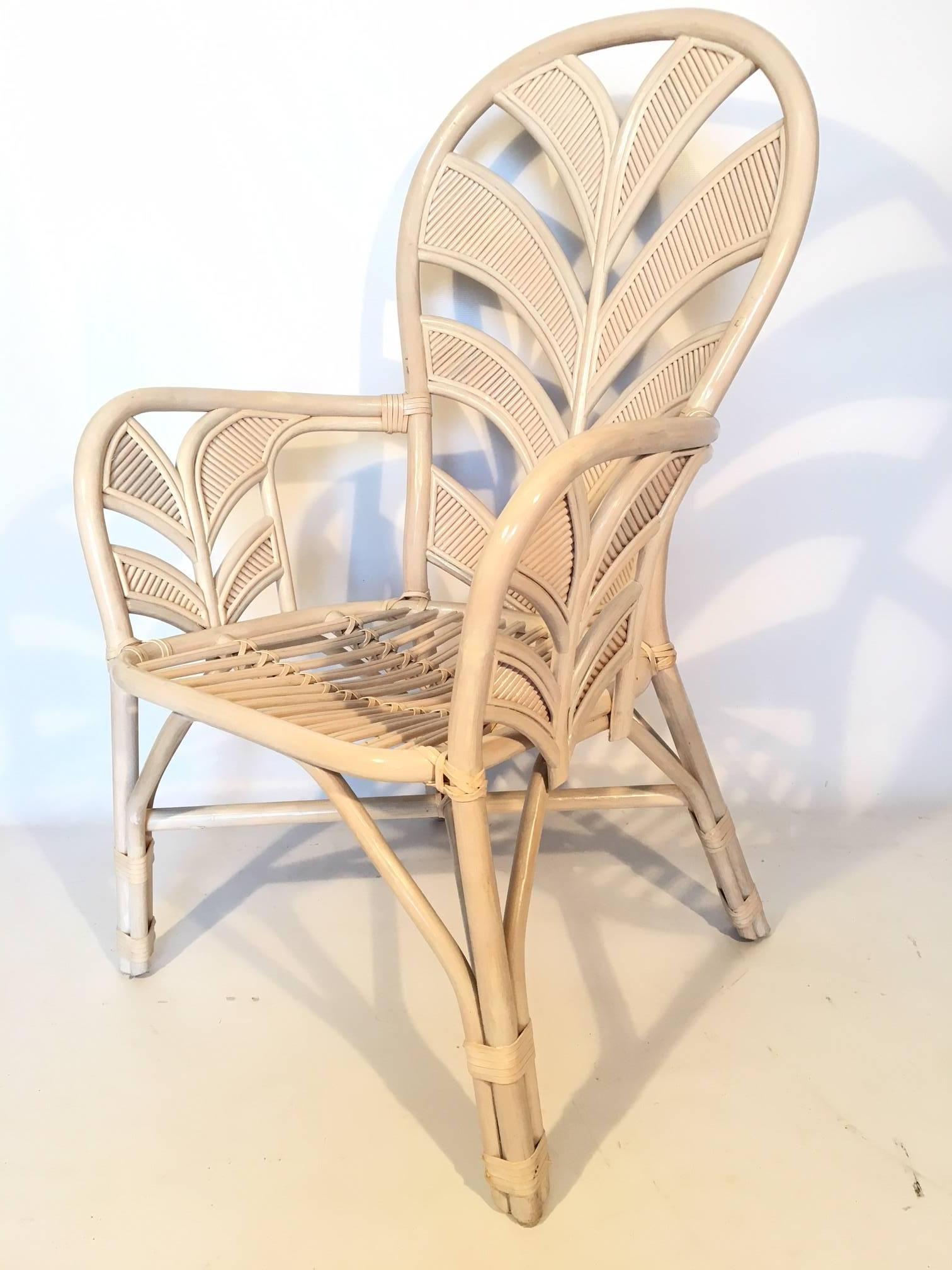 Midcentury rattan arm chairs feature sculptural palm frond motif for a touch of vintage Palm Beach style in any decor. Excellent condition both structurally and cosmetically. Chairs can be purchased individually in any quantity (ten available). Six